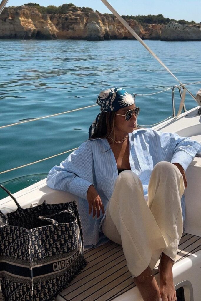 pinstripe yacht shirt, cream trousers, and silk headscarf