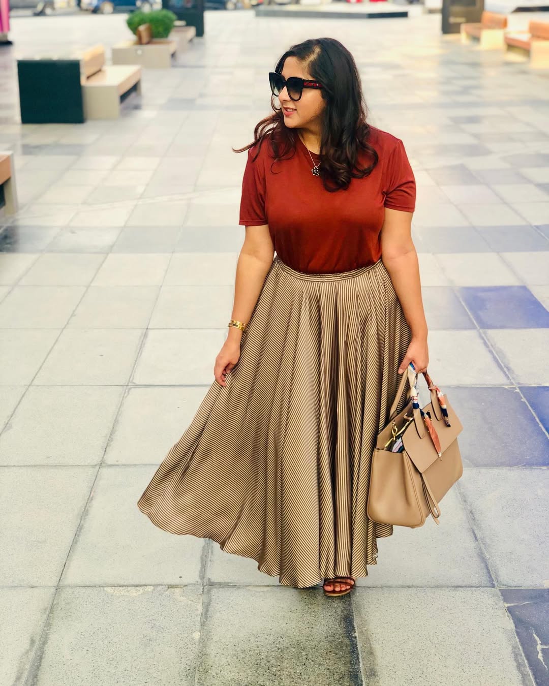 Rust Tee With Striped Maxi Skirt And Tan Tote