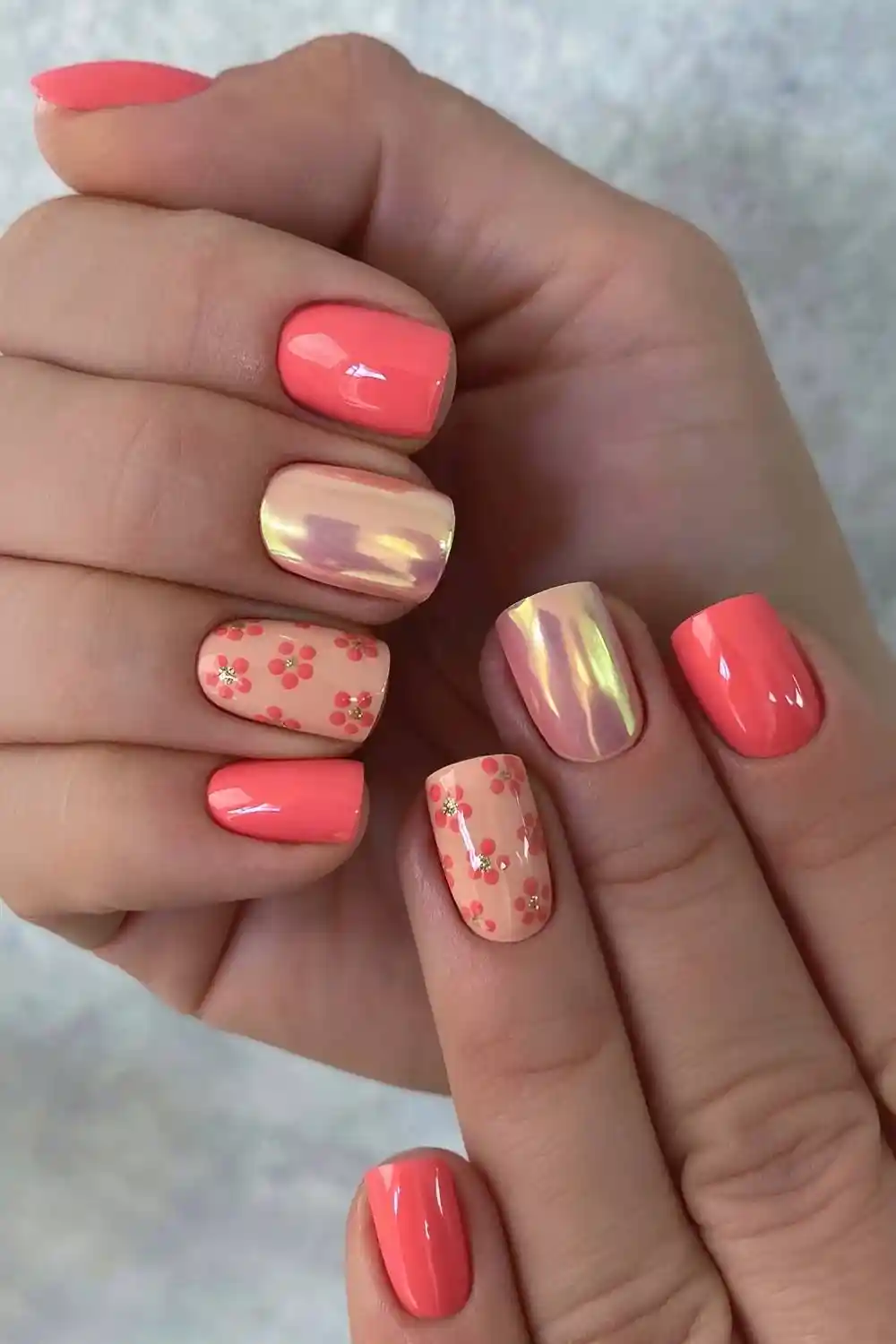 Coral nails with gold and floral accents