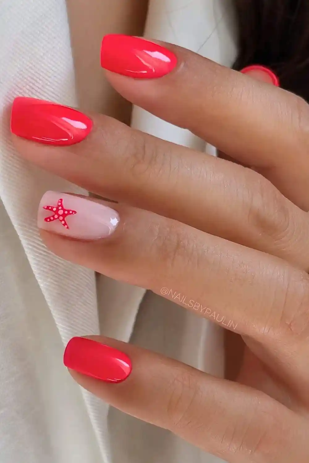 Bright red nails with accent starfish