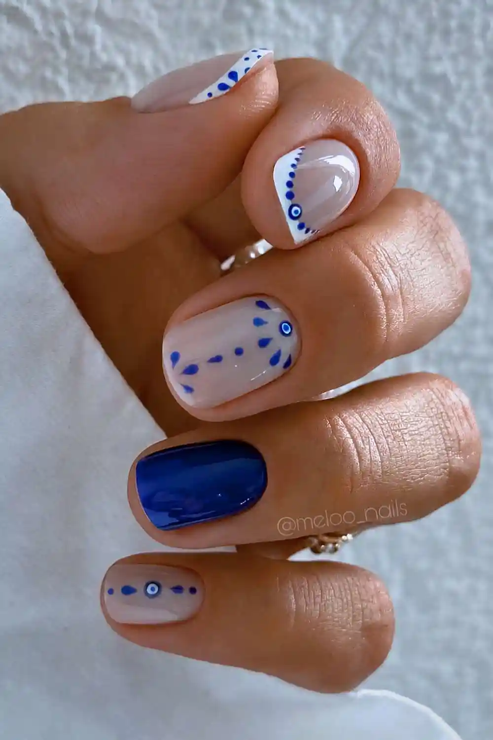 Short blue and white evil eye nails