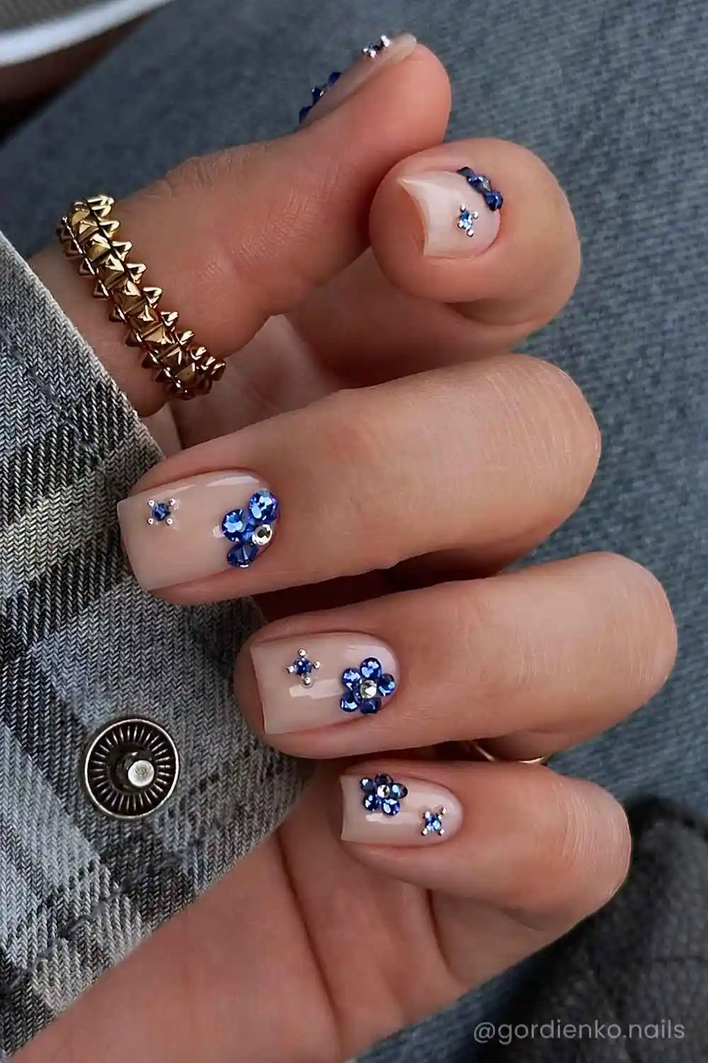 Short milky mani with blue gem florals