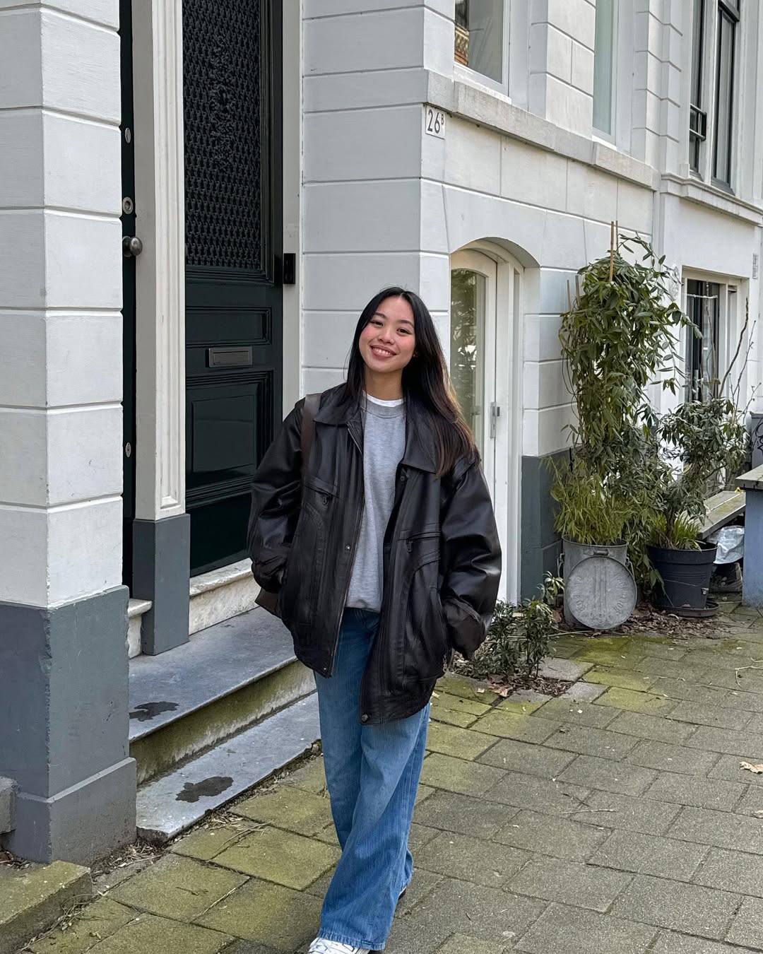 Black Leather Jacket With Relaxed Jeans and Sneakers