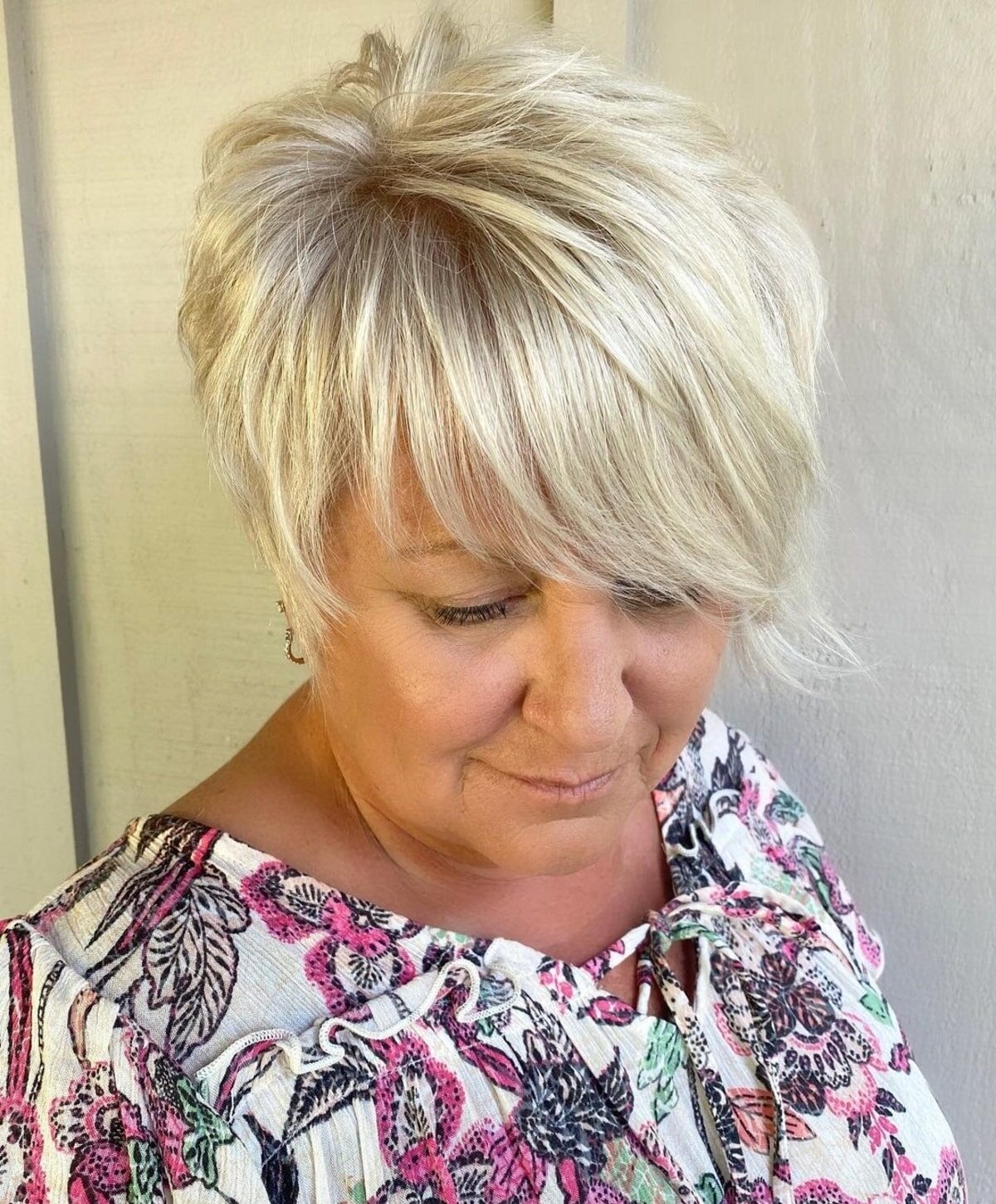 Asymmetrically Long Pixie with Side Bangs for women over sixty