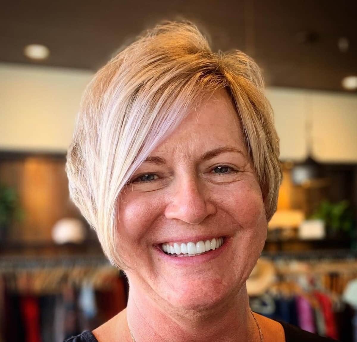 Asymmetrical haircut with layering for women in their 60s with fine Hair