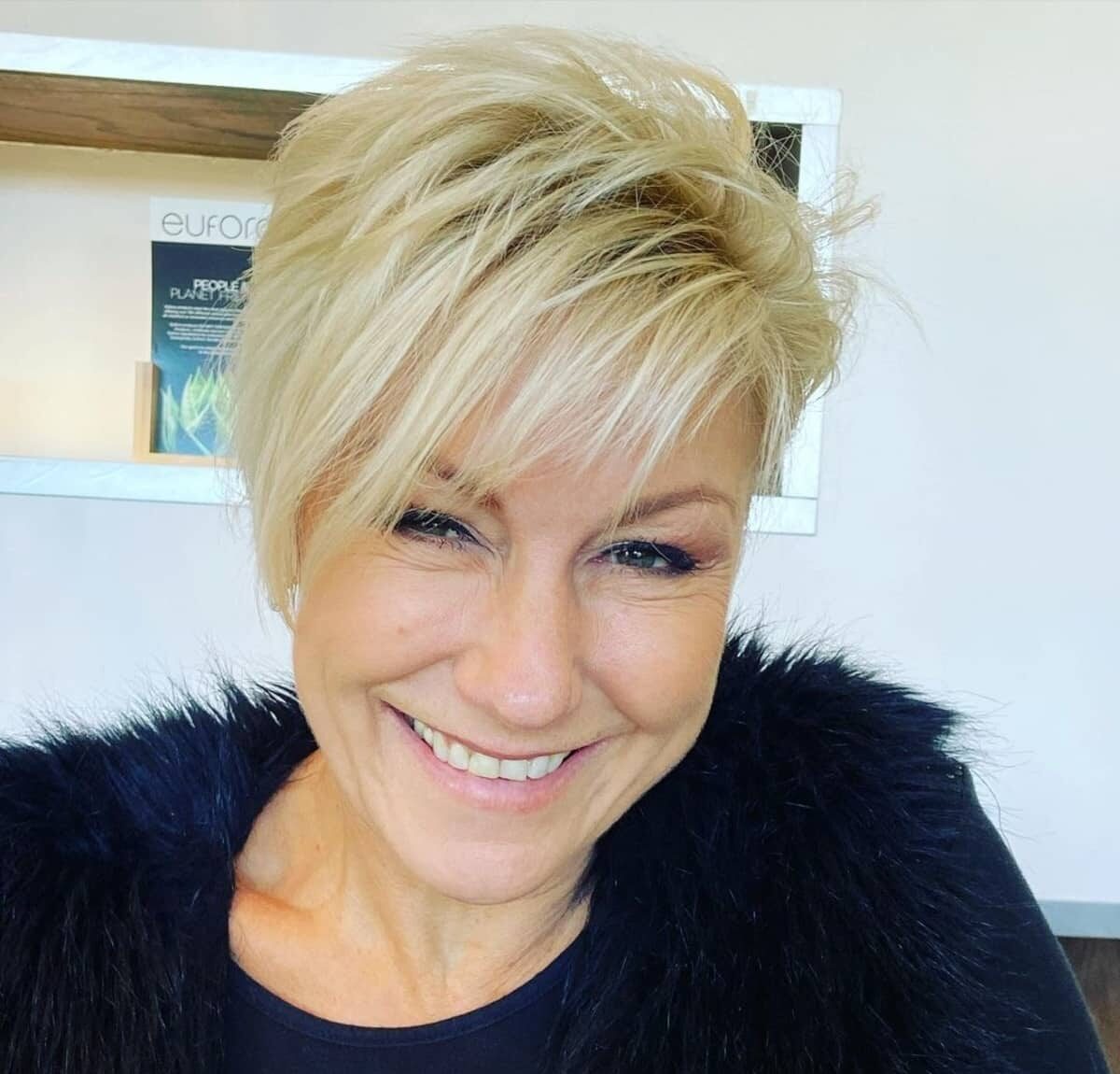 Short asymmetrical cut with feathered layers for ladies over 60
