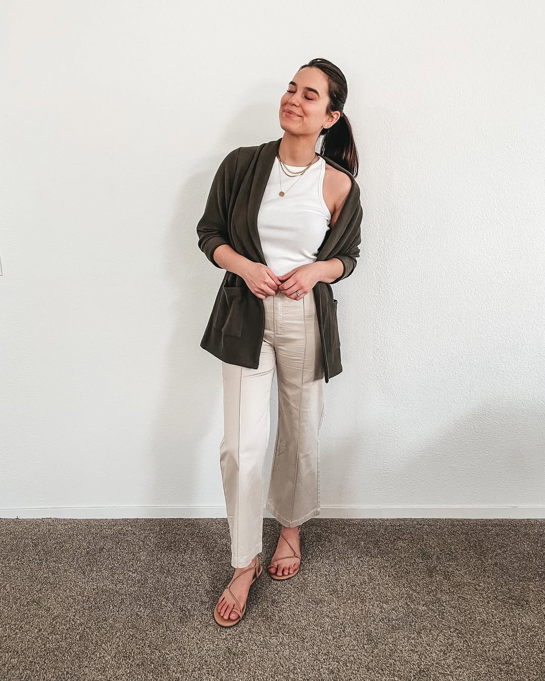 Olive Cardigan Over White Tank And Khaki Trousers