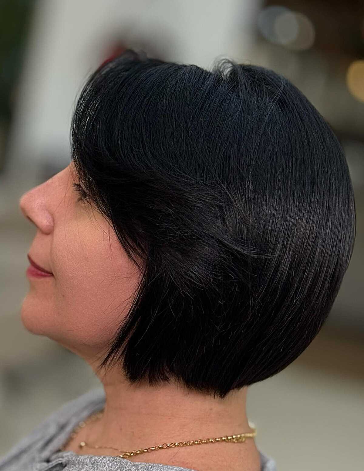 25 Below-the-Chin Bob Hairstyles Taking Over Salons Jet black rounded bob with side-swept layers
