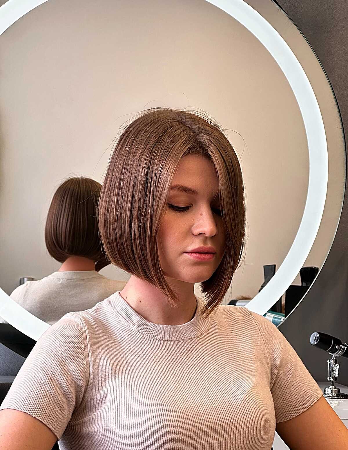 25 Below-the-Chin Bob Hairstyles Taking Over Salons Angled bronde bob with smooth blowout just below chin