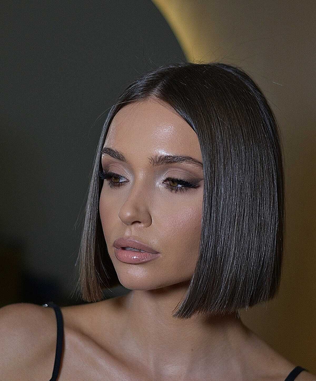 25 Below-the-Chin Bob Hairstyles Taking Over Salons Sleek dark brown glass-finish bob below the chin