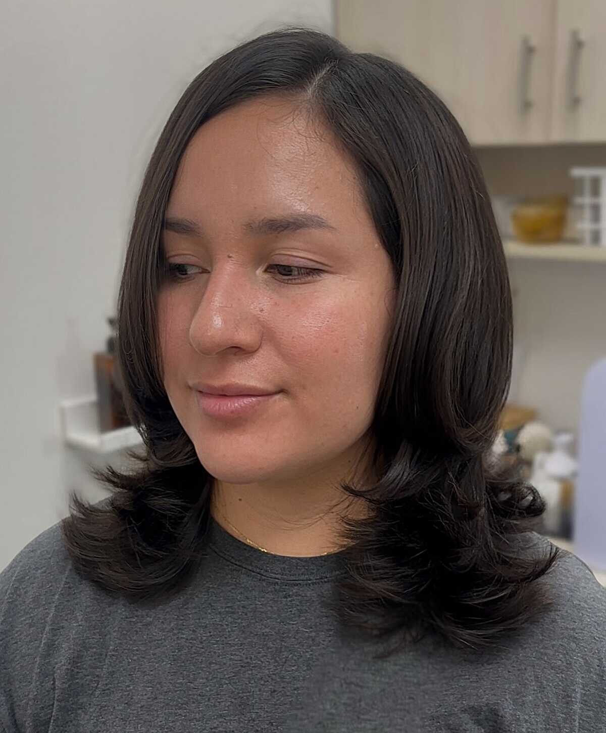 Black curly blowout with bangs and roller-set waves