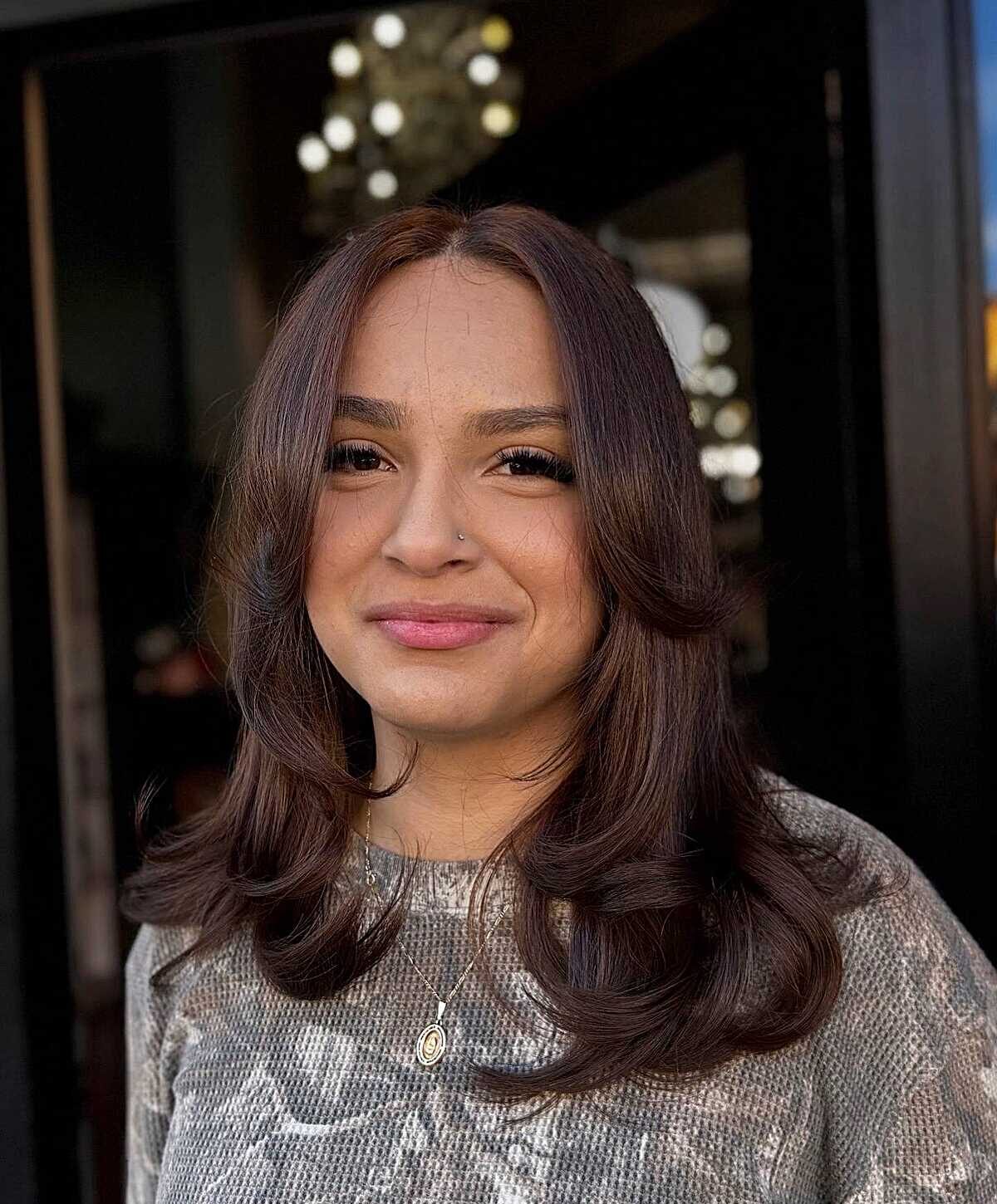 Plum-toned brunette bouncy mid-length blowout