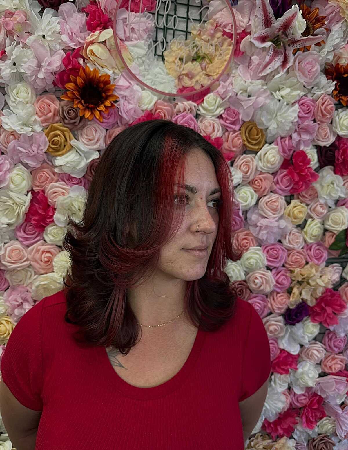 Dark hair with red face-framing highlights and blowout
