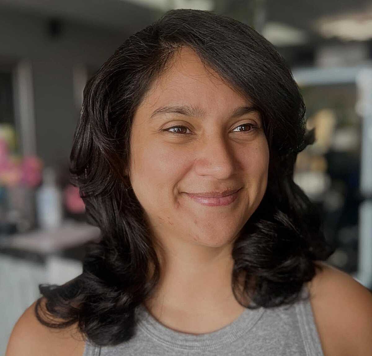 Dark wavy mid-length blowout with center part