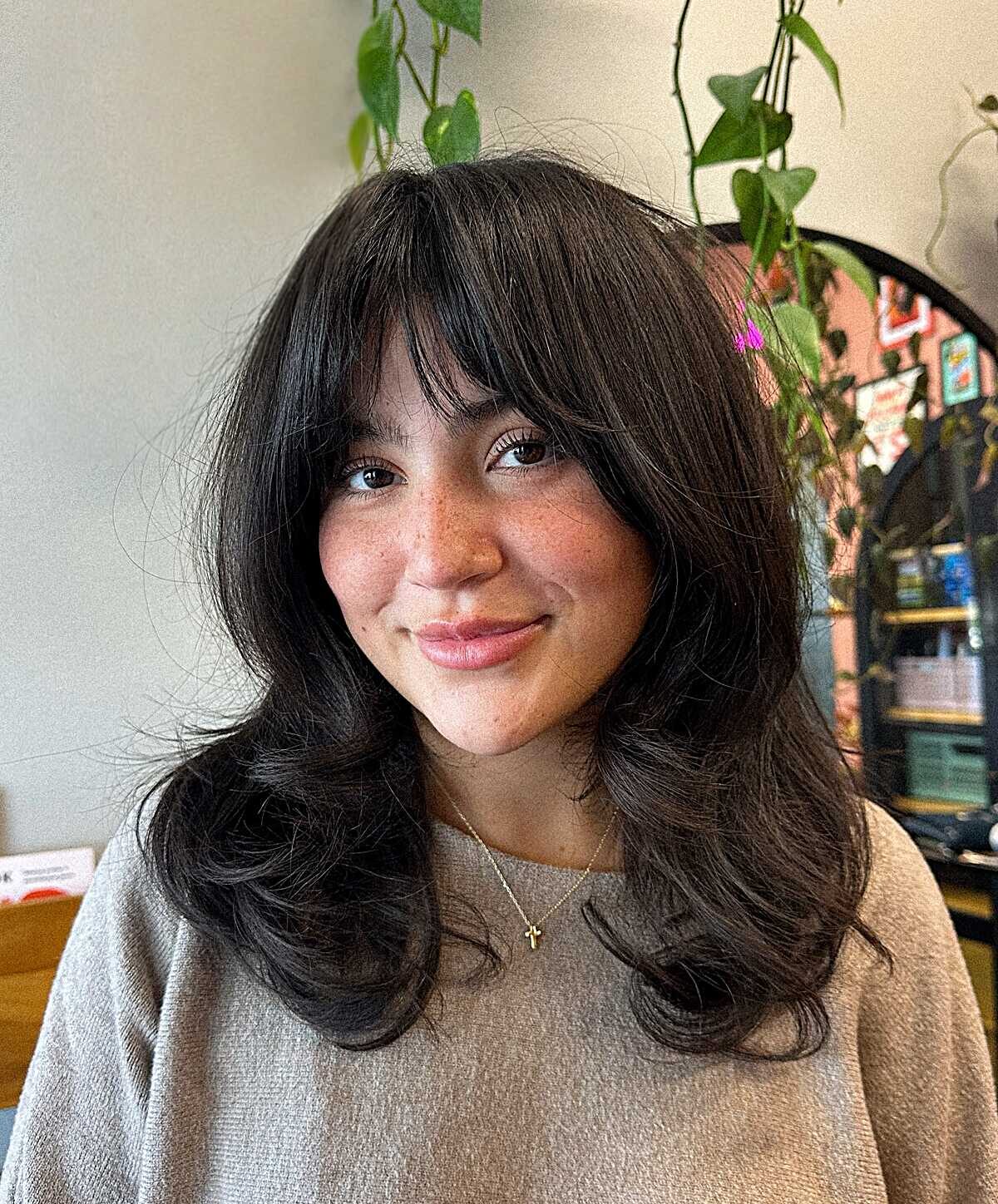 Dark brown blowout with full bangs and wavy ends