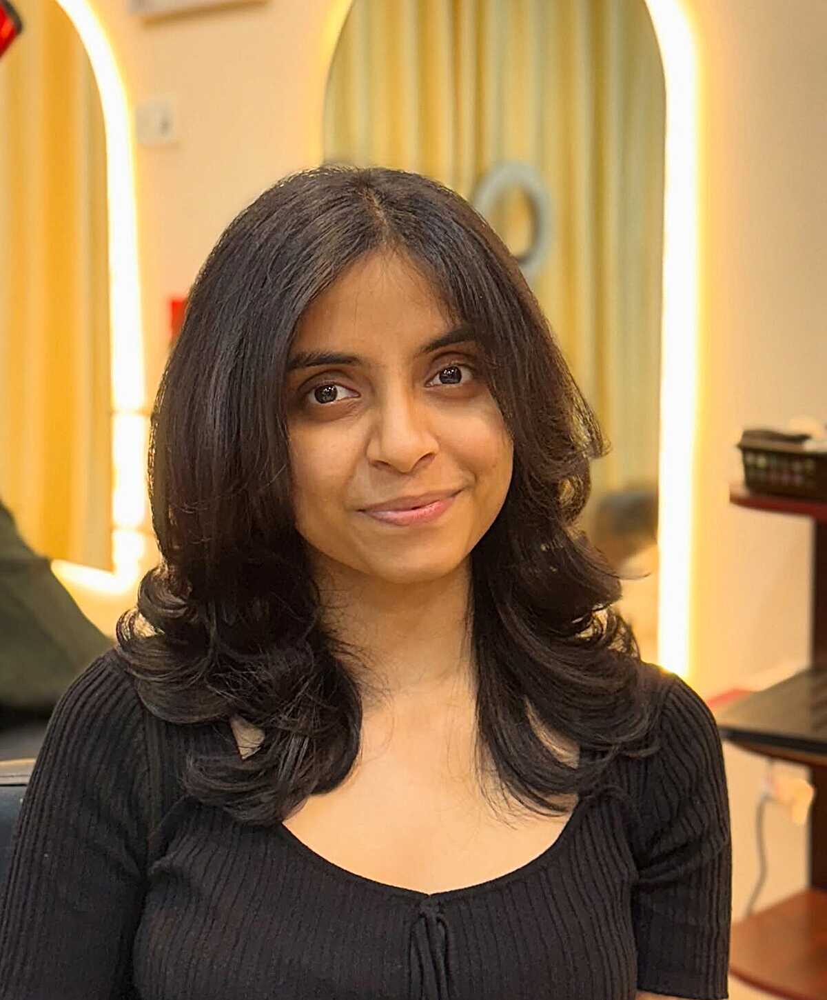Black layered mid-length blowout with curled ends