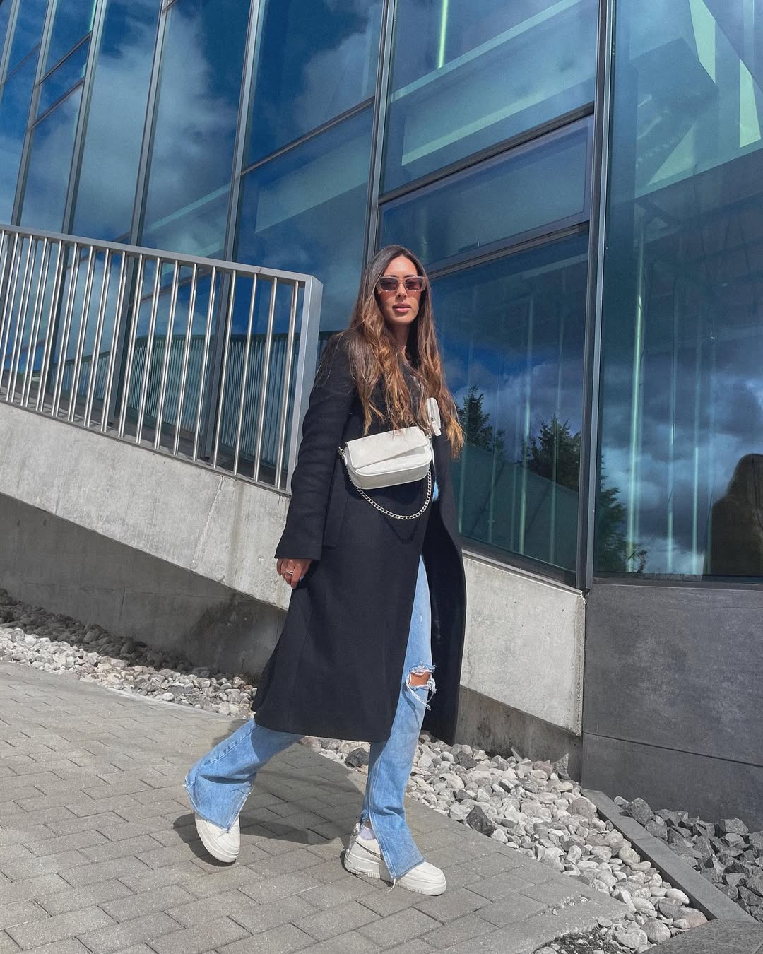 Long Black Coat With Ripped Denim & White Sneakers