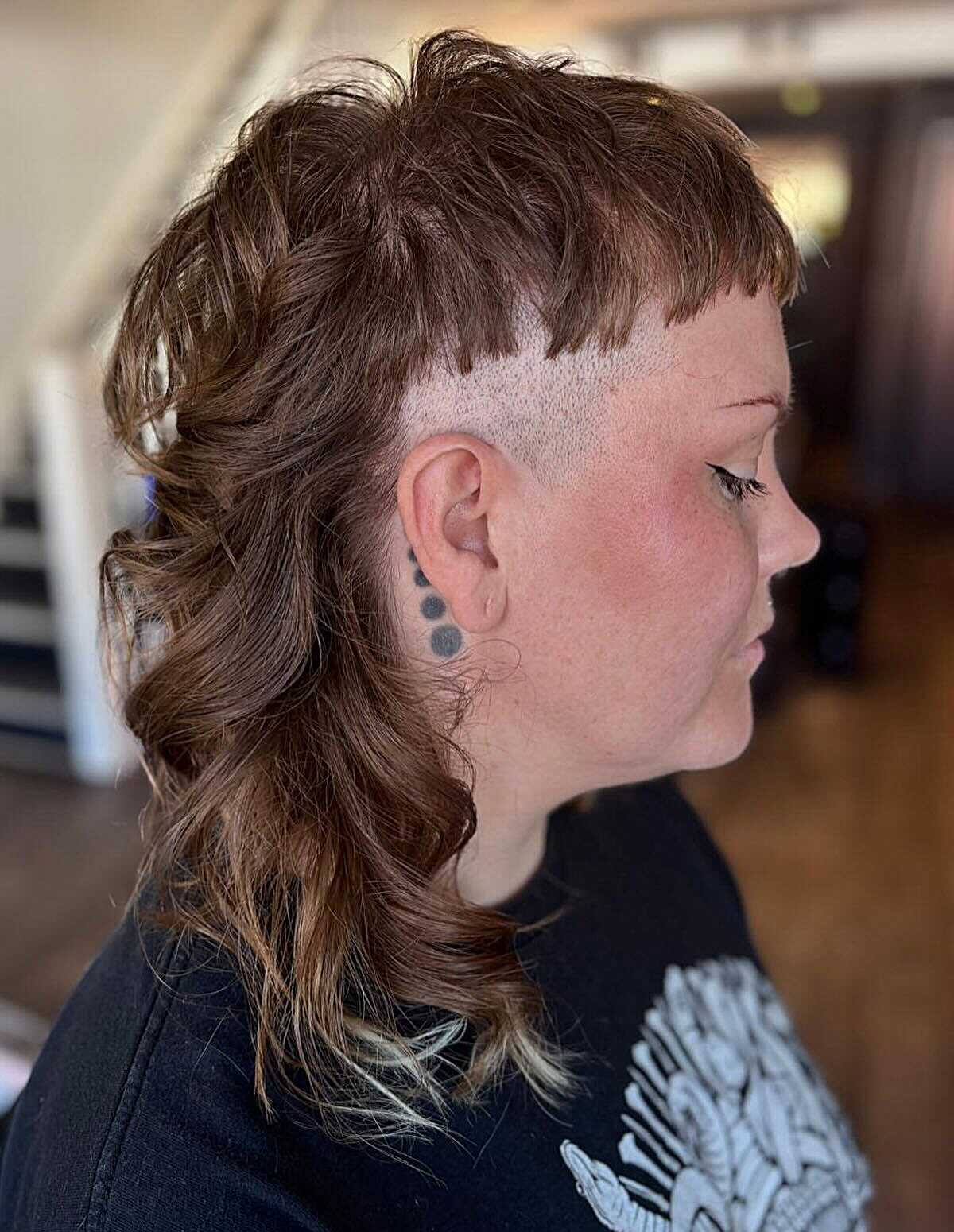 Wavy brown mullet with shaved sides and long back