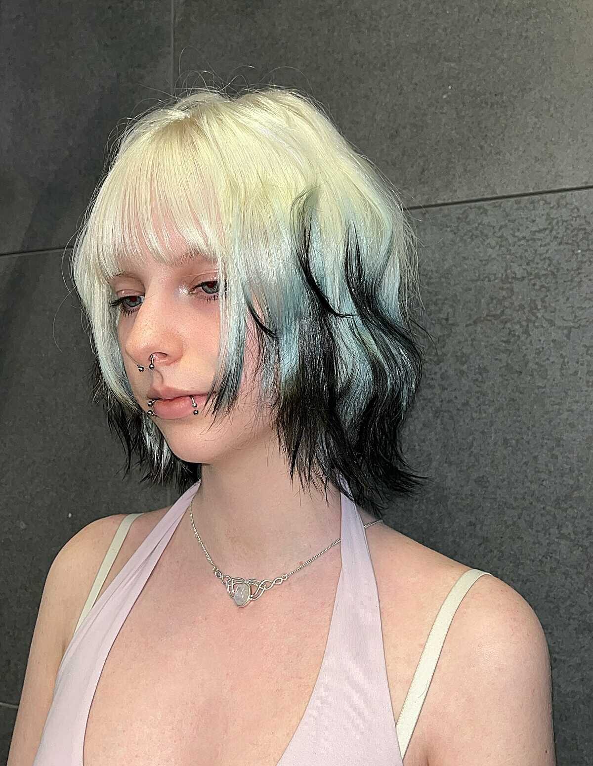 Wavy bob with platinum blonde top and black underneath
