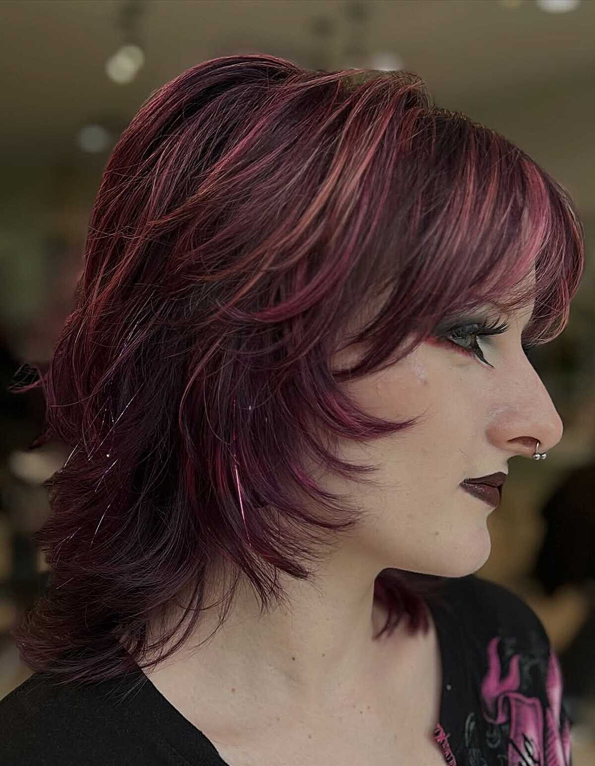 Feathered layers in deep burgundy with pink highlights