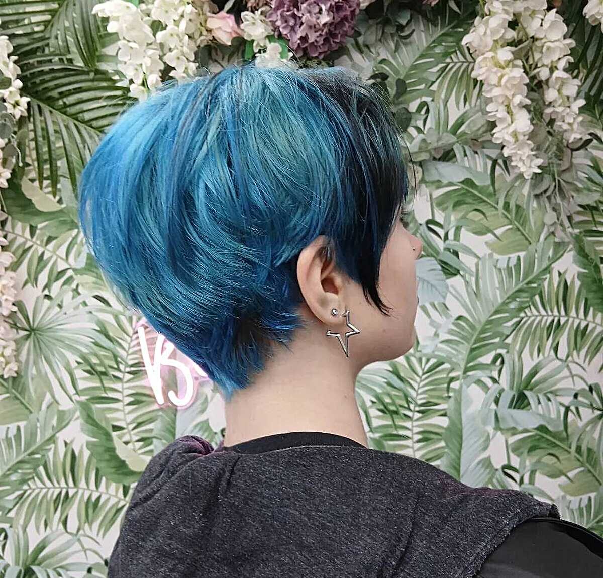 Teal blue pixie cut tapered at the nape