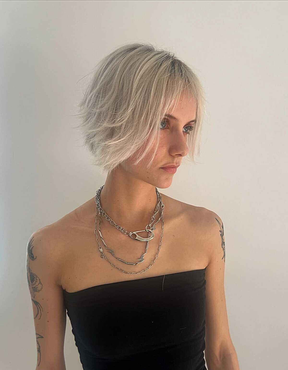 Razored platinum bob with dark grown-out roots