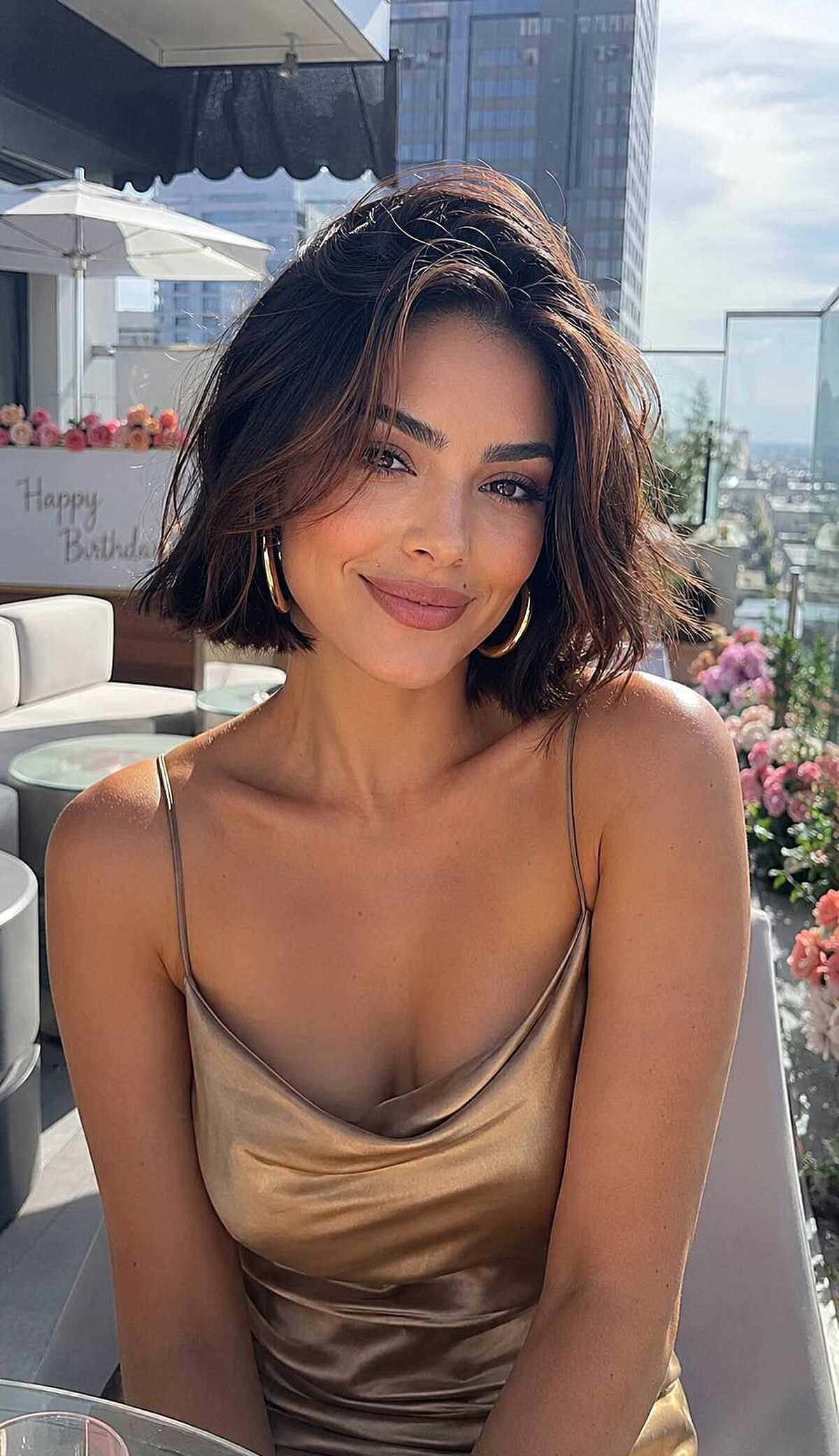 Short chocolate brown bob with flipped ends at party
