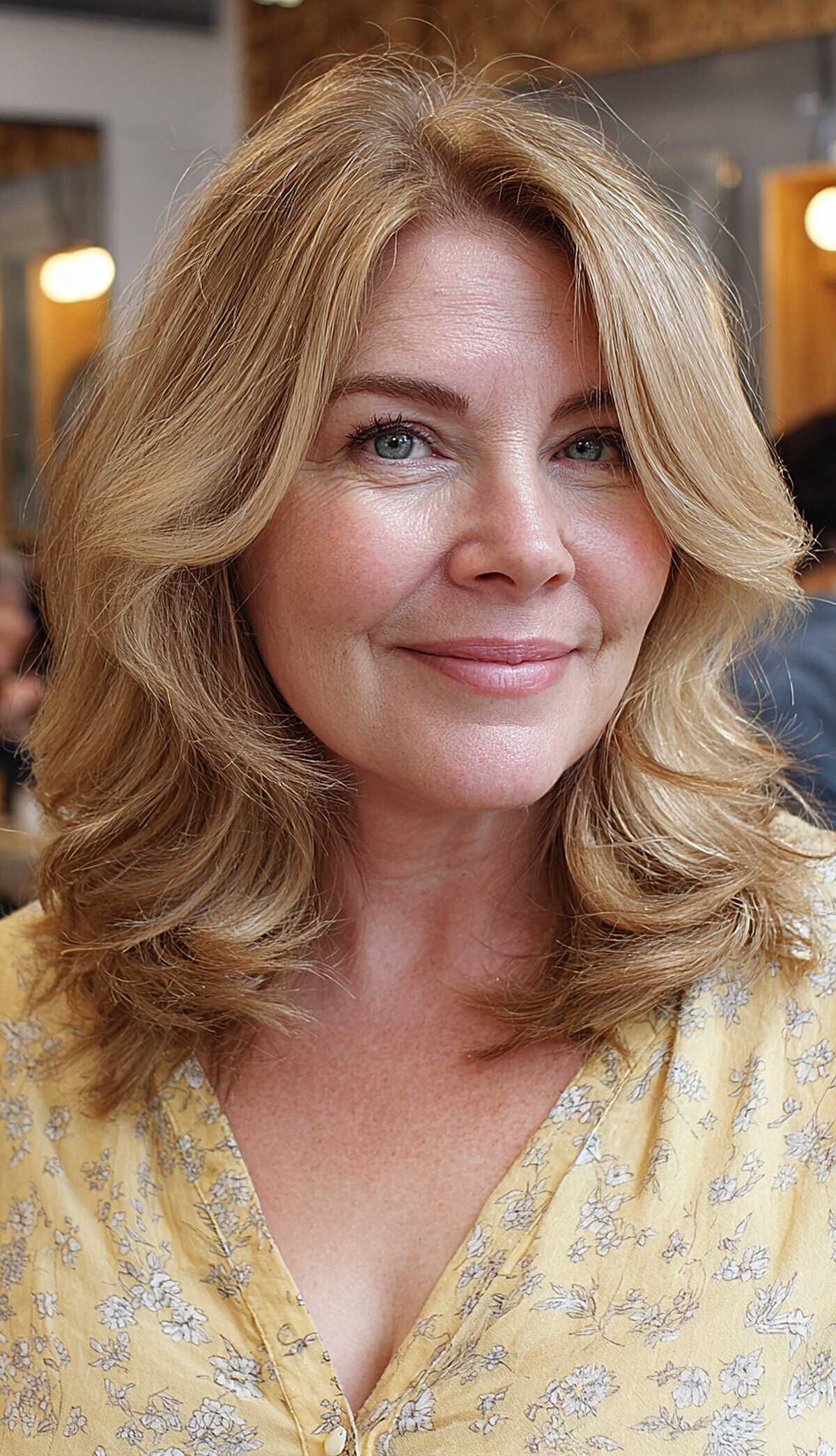 Golden blonde lob with feathered layers on round face