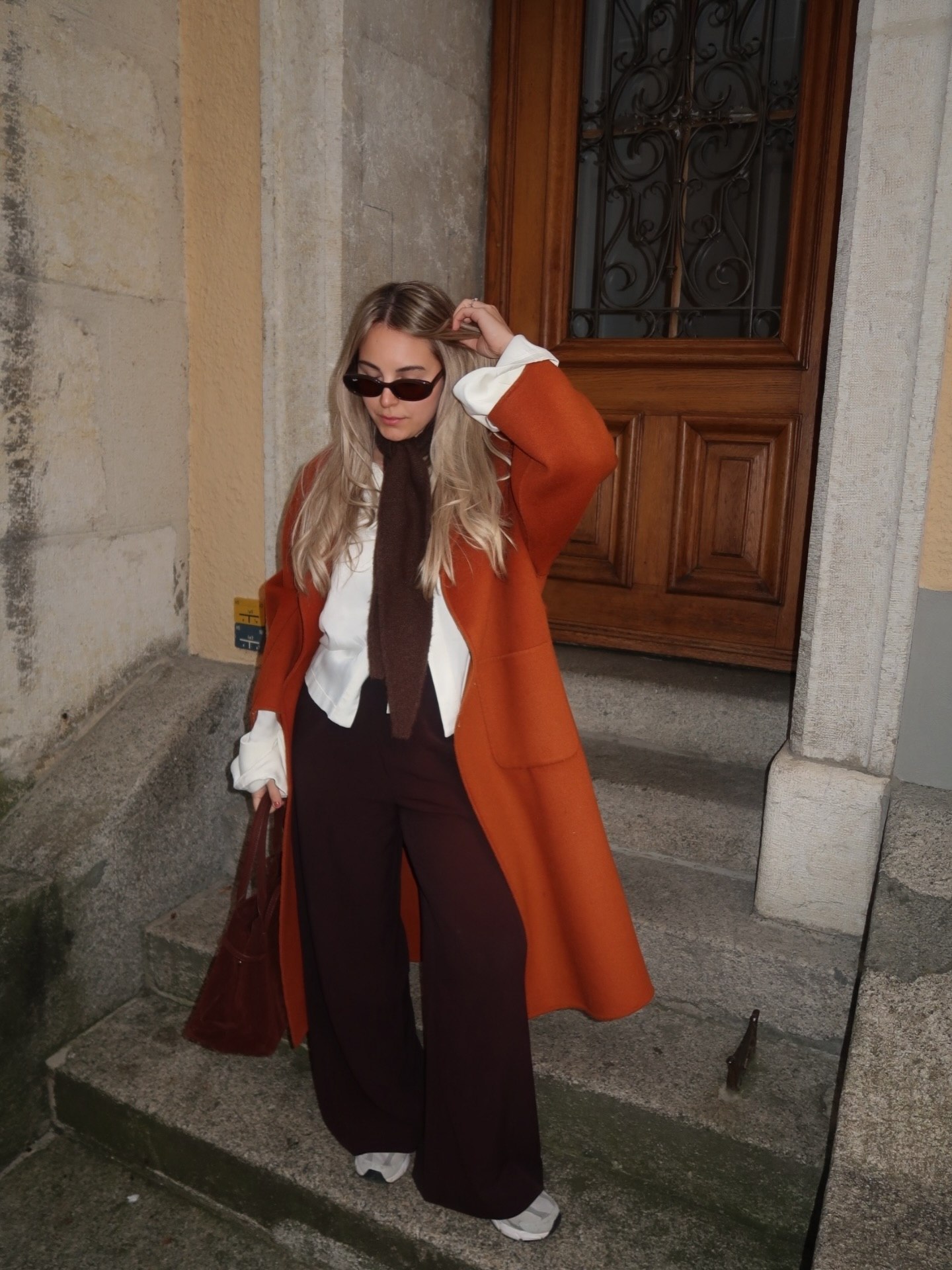 Burnt Orange Coat Over White Shirt And Wide Leg Pants