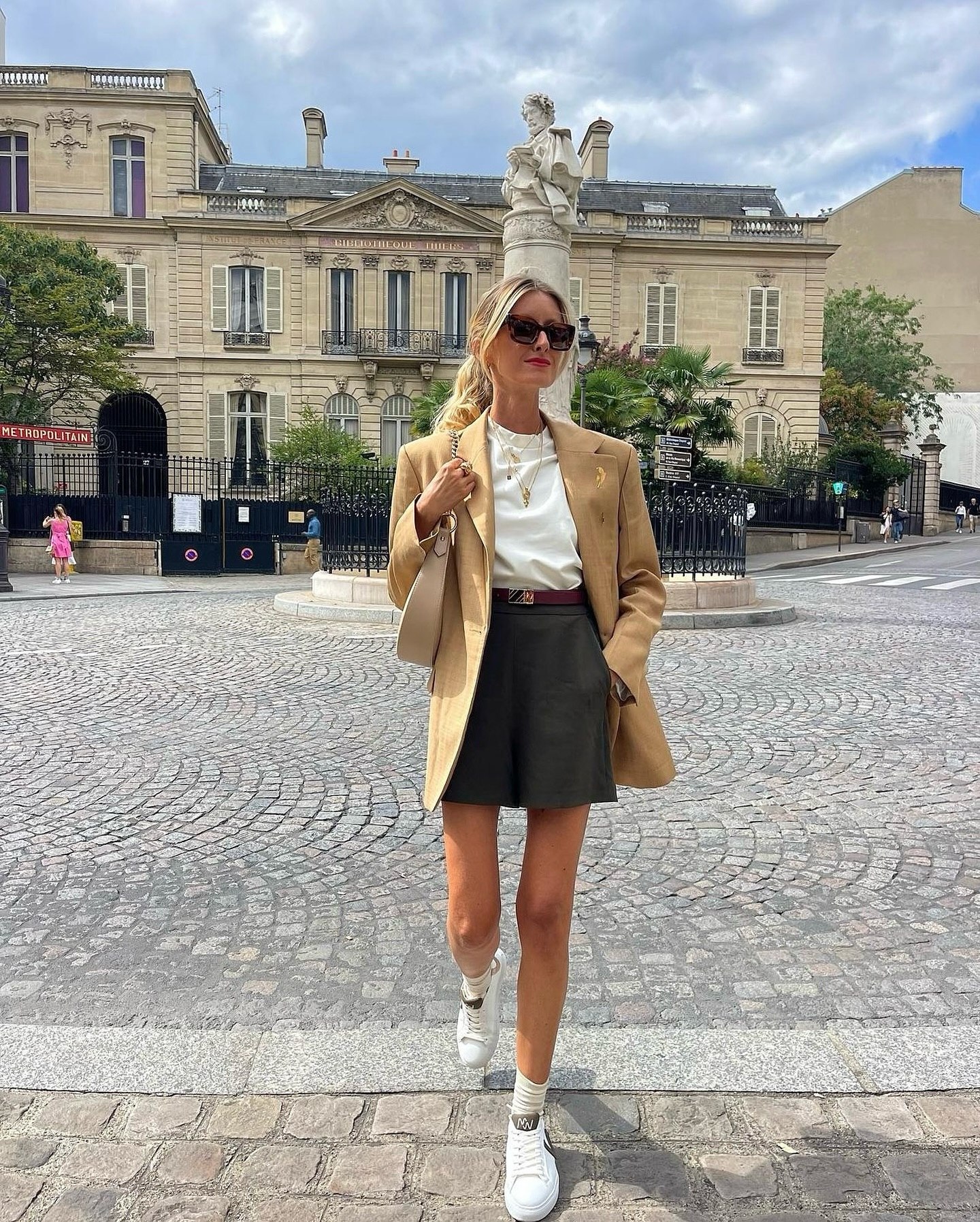 Tan Blazer With Dark Shorts And Sneakers