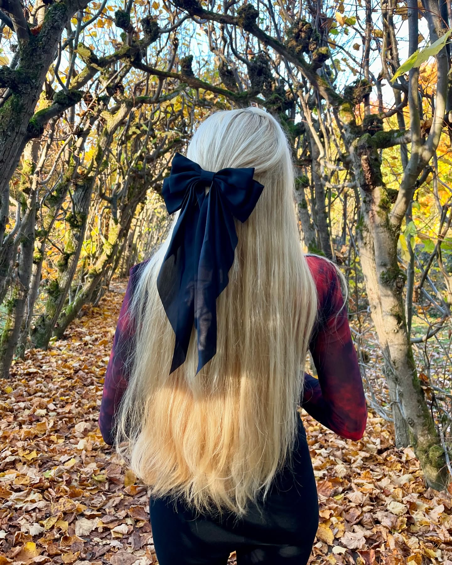 Long Blonde Waves With Black Satin Bow