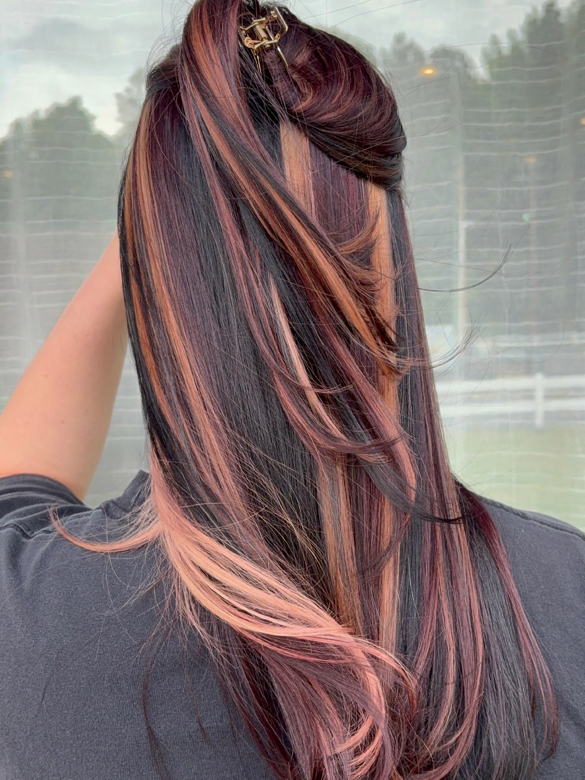 Subtle Rose Gold Streaks On Deep Brunette Waves
