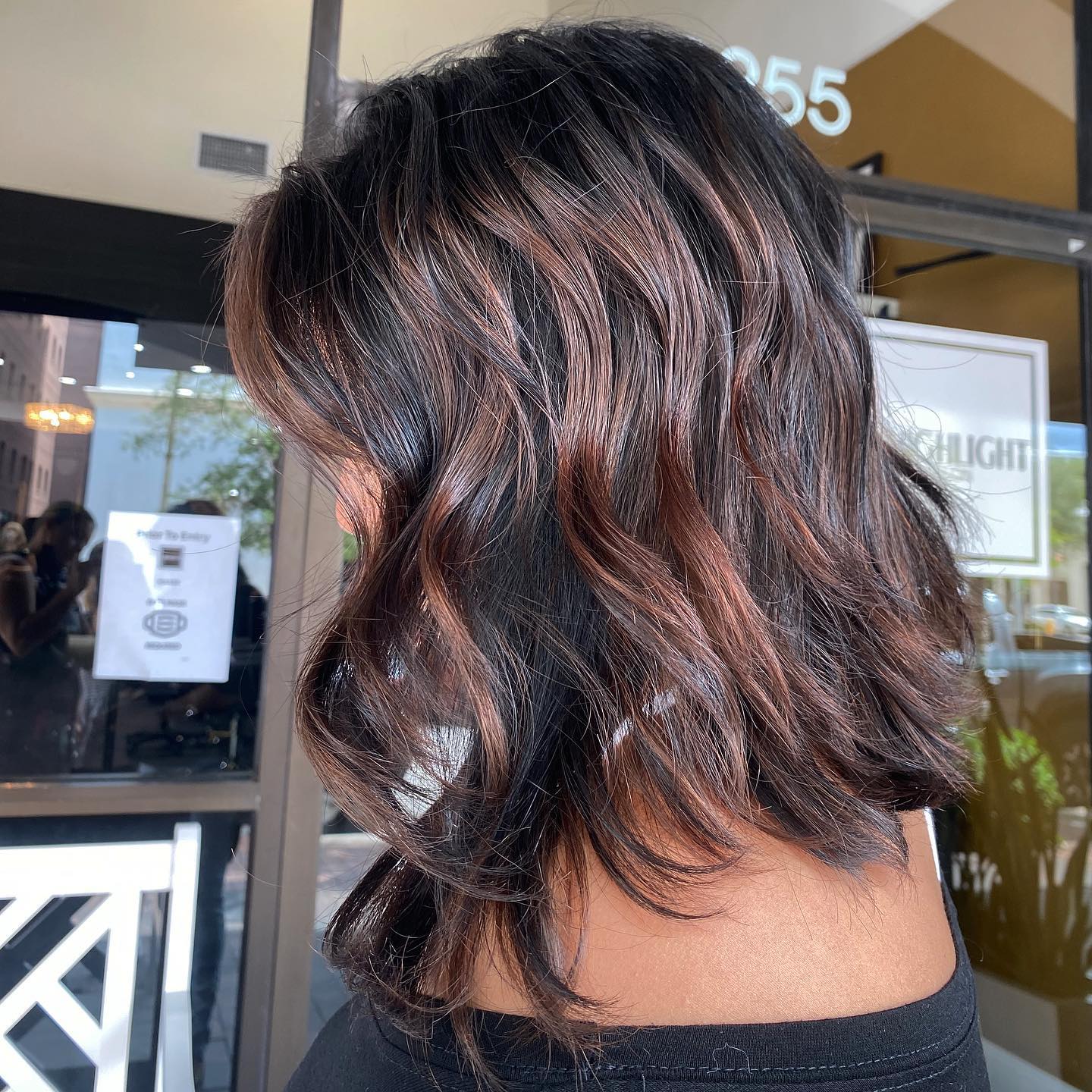 Warm Copper Highlights On Dark Wavy Lob