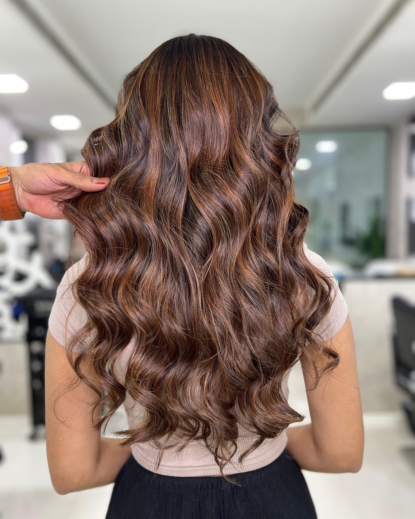 Warm Auburn Highlights On Long Wavy Brunette