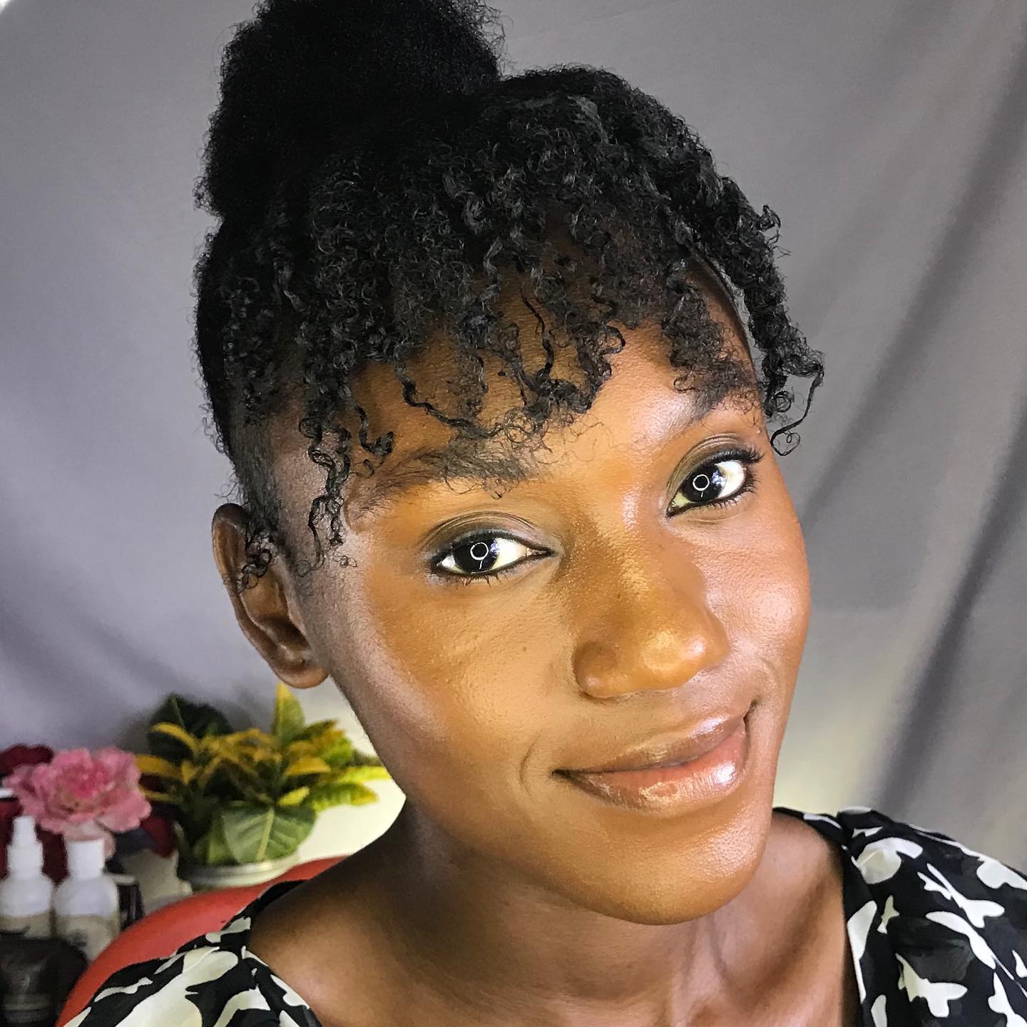 Elevated High Bun With Curly Face-Framing Tendrils