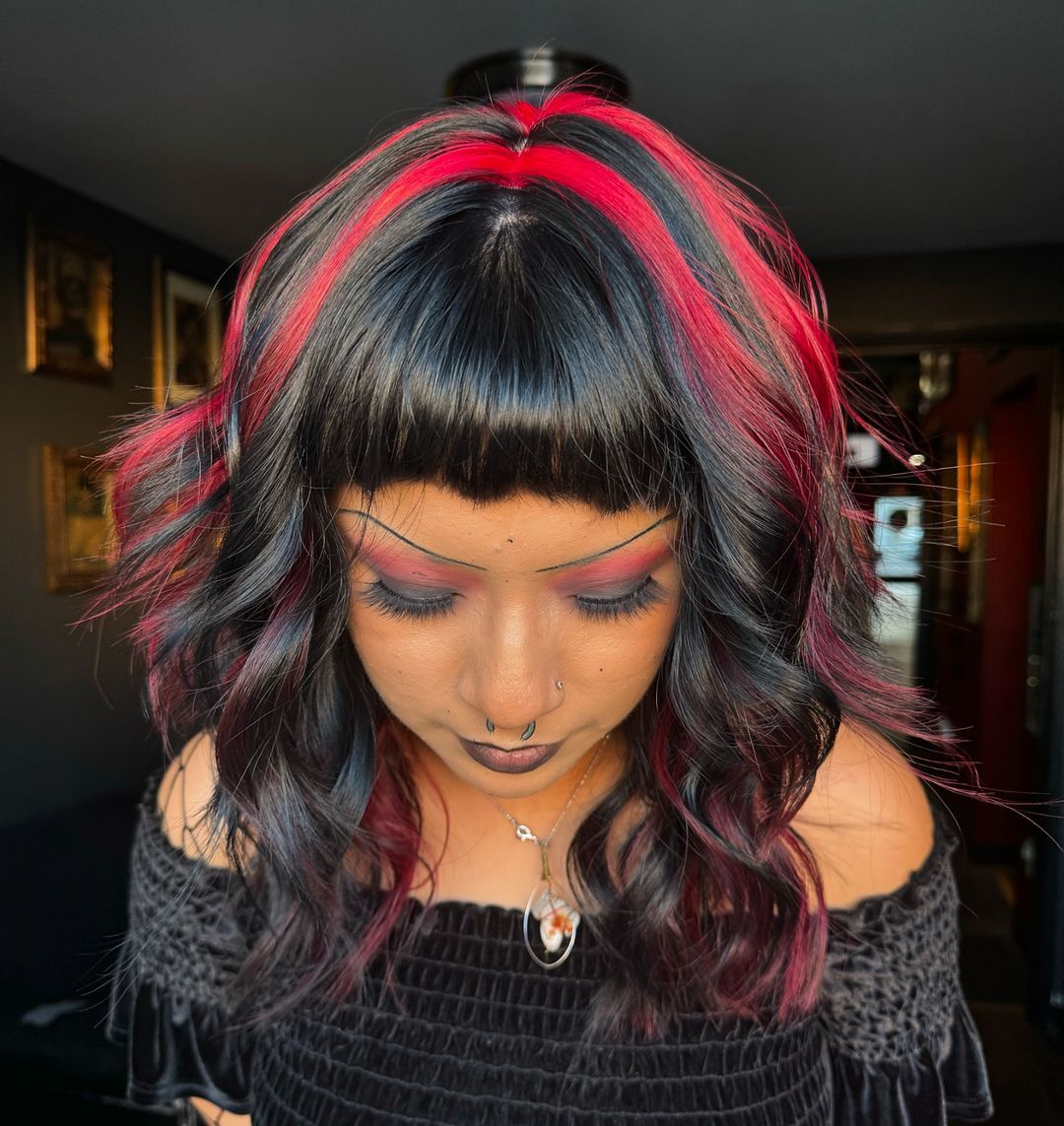 Bold Red Streaks On Dark Wavy Bob