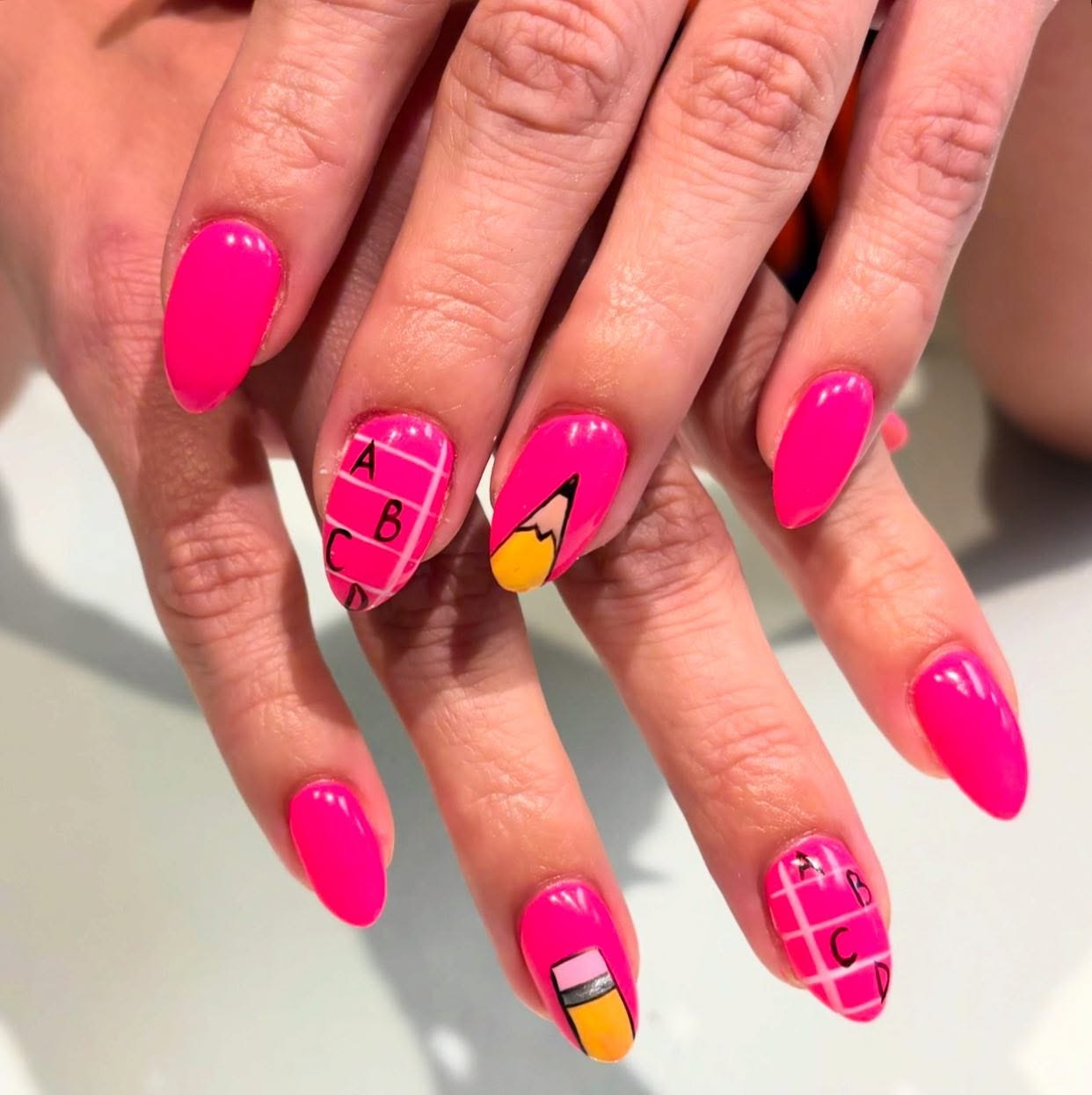 Hot Pink Pencil And Alphabet Grid Nails