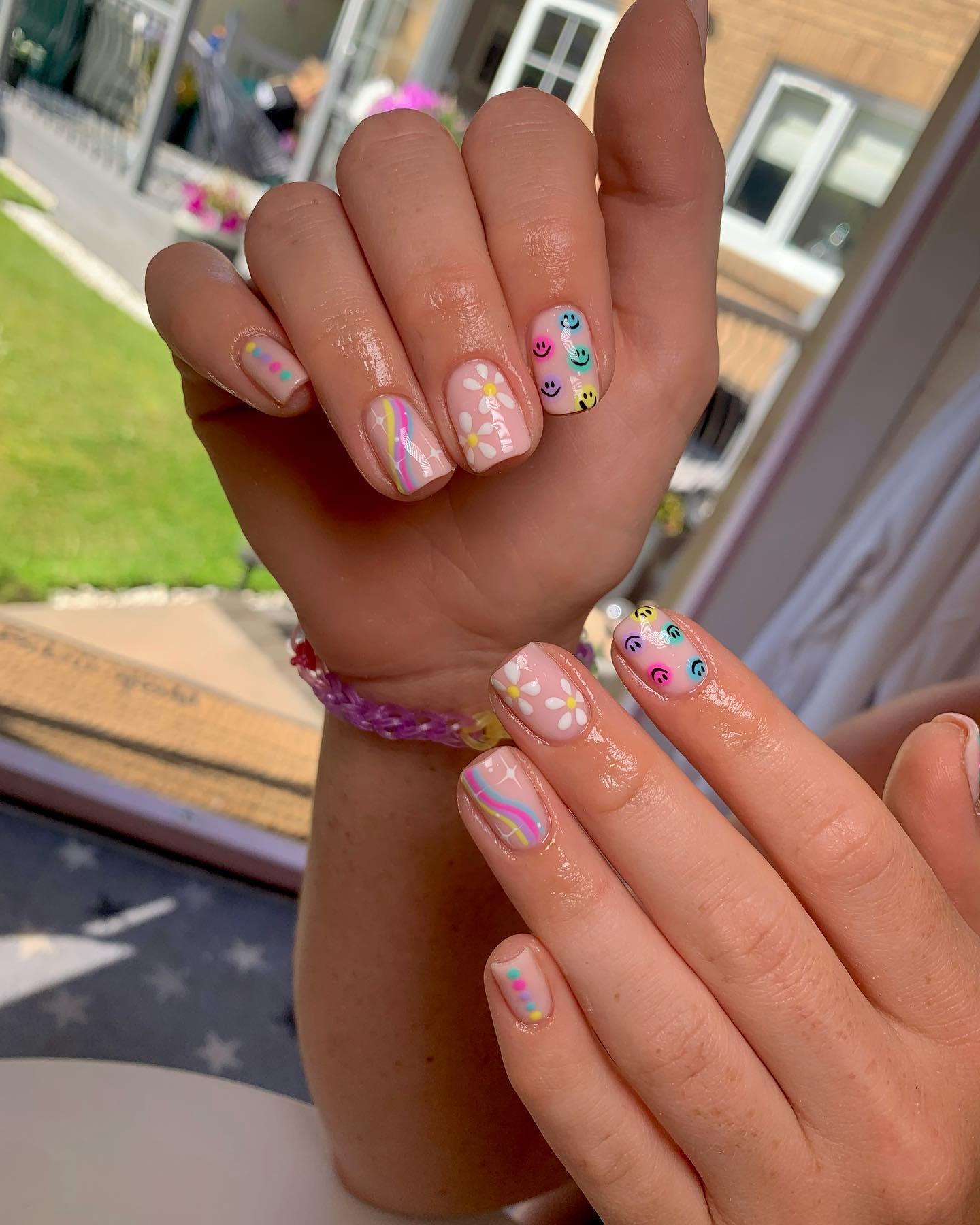 Playful Pastel Smiley Face & Daisy Nails