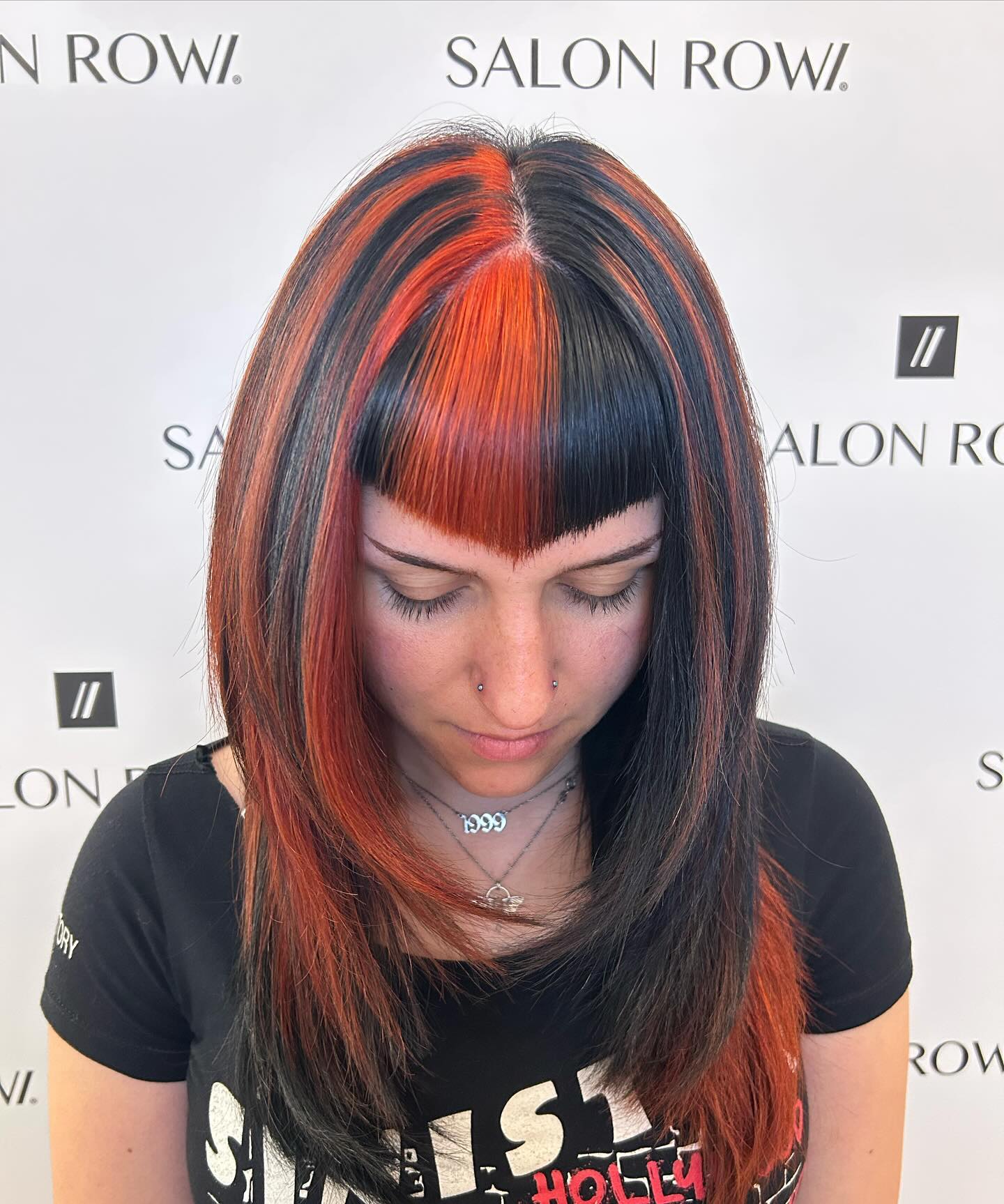 Vibrant Orange And Black Striped Hair With Blunt Bangs