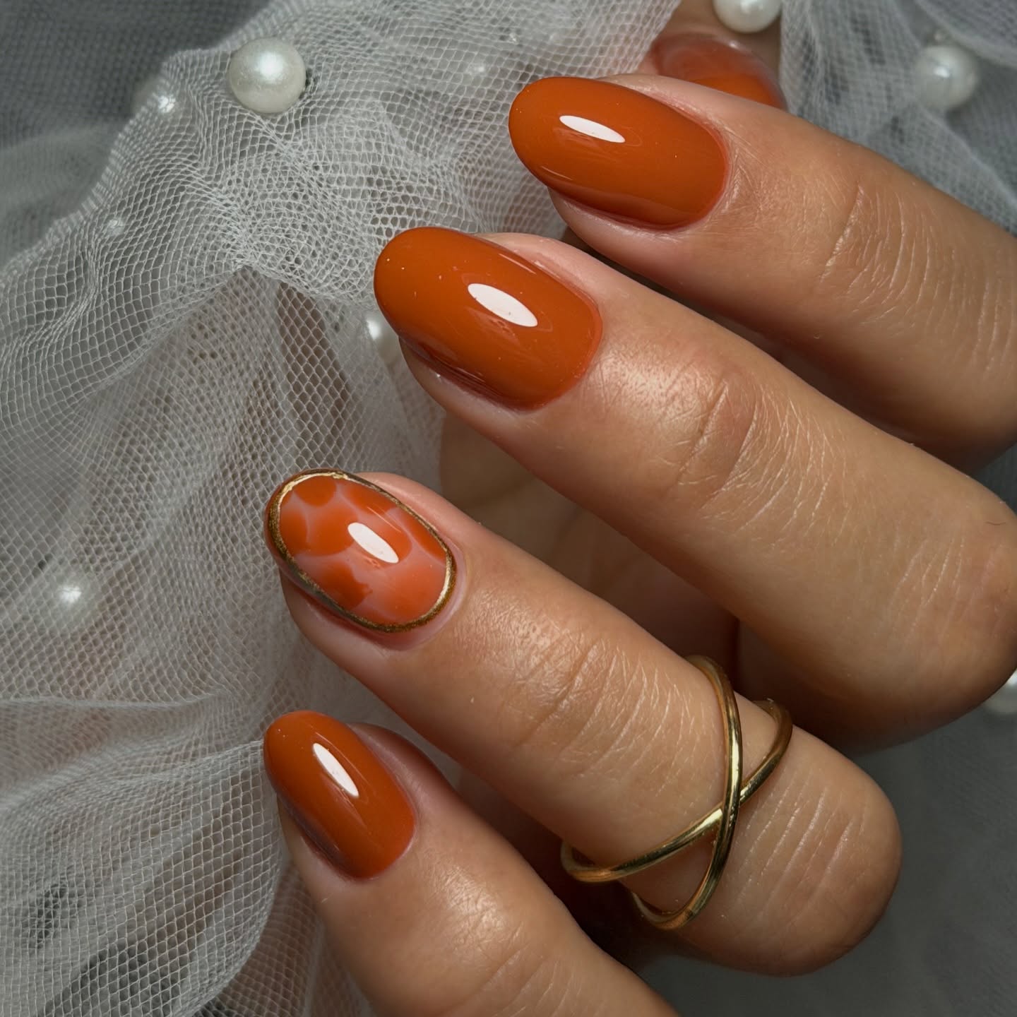 Glossy Terracotta Oval Nails with Marble Accent