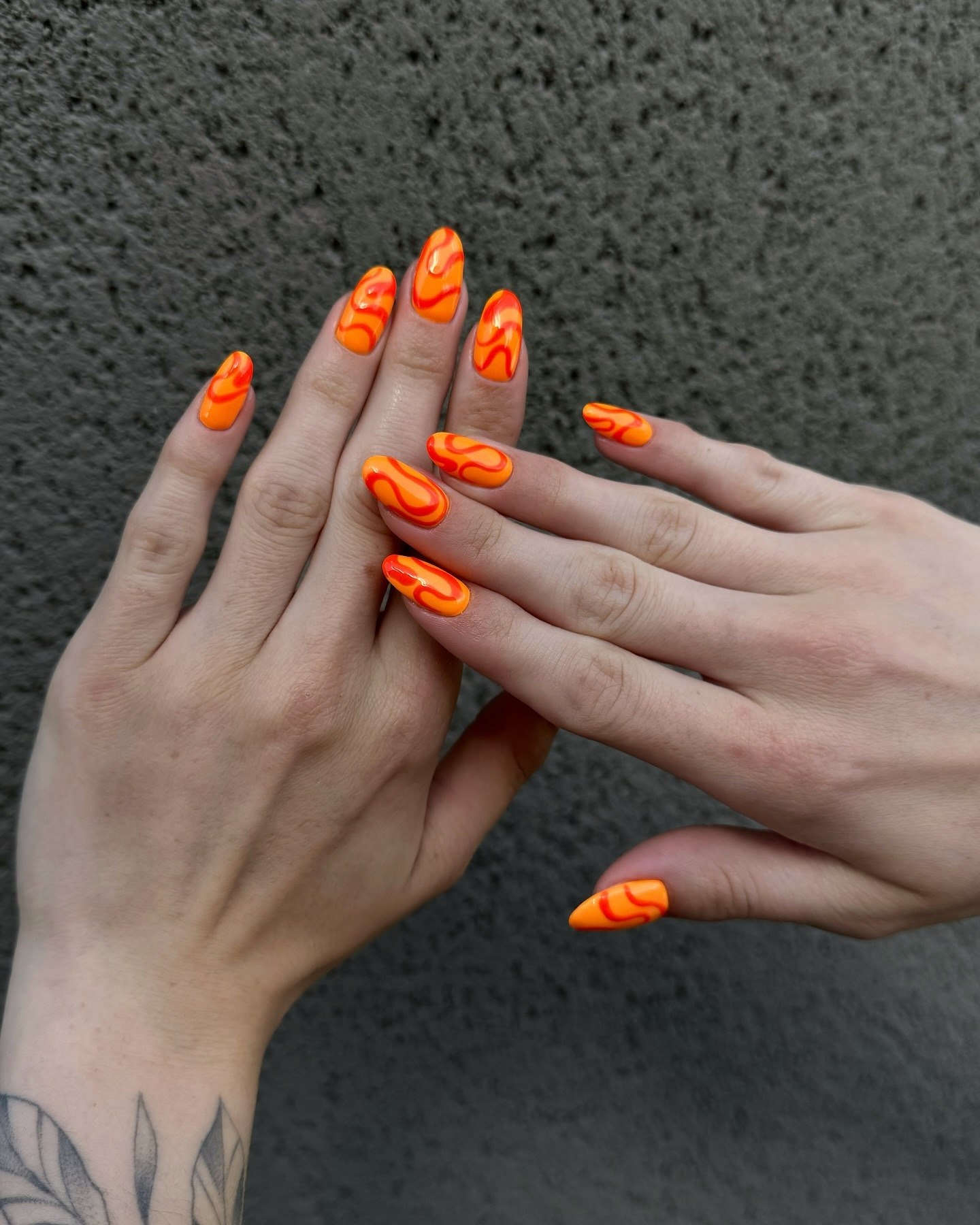 Fiery Orange Swirl Almond Nails