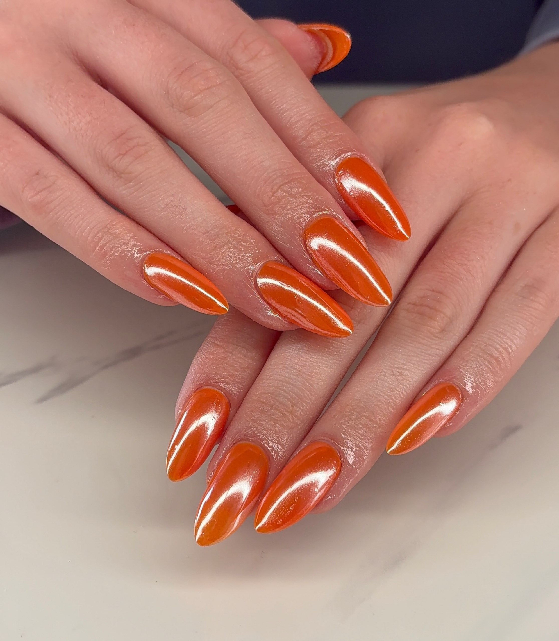 Glossy Tangerine Chrome Stiletto Nails