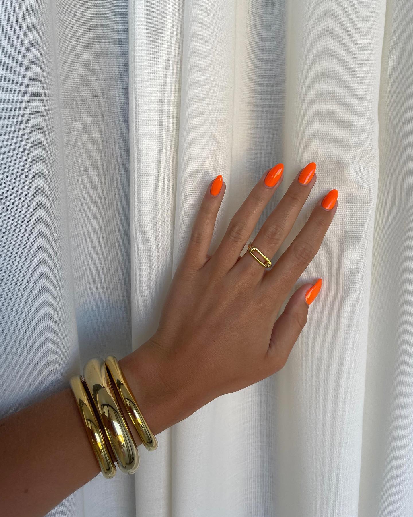 Vibrant Orange Glossy Almond Nails