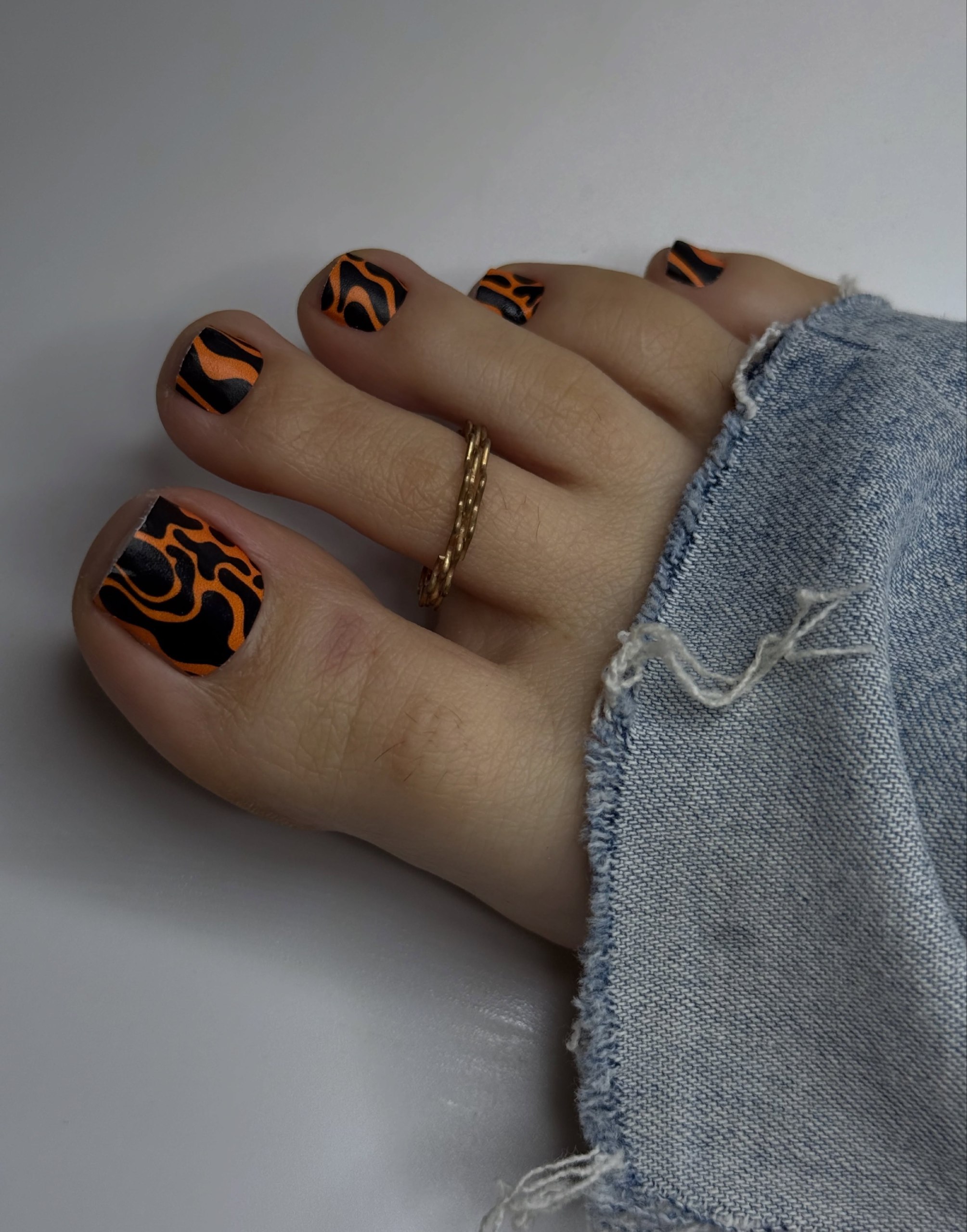 Matte Orange and Black Swirl Pedicure
