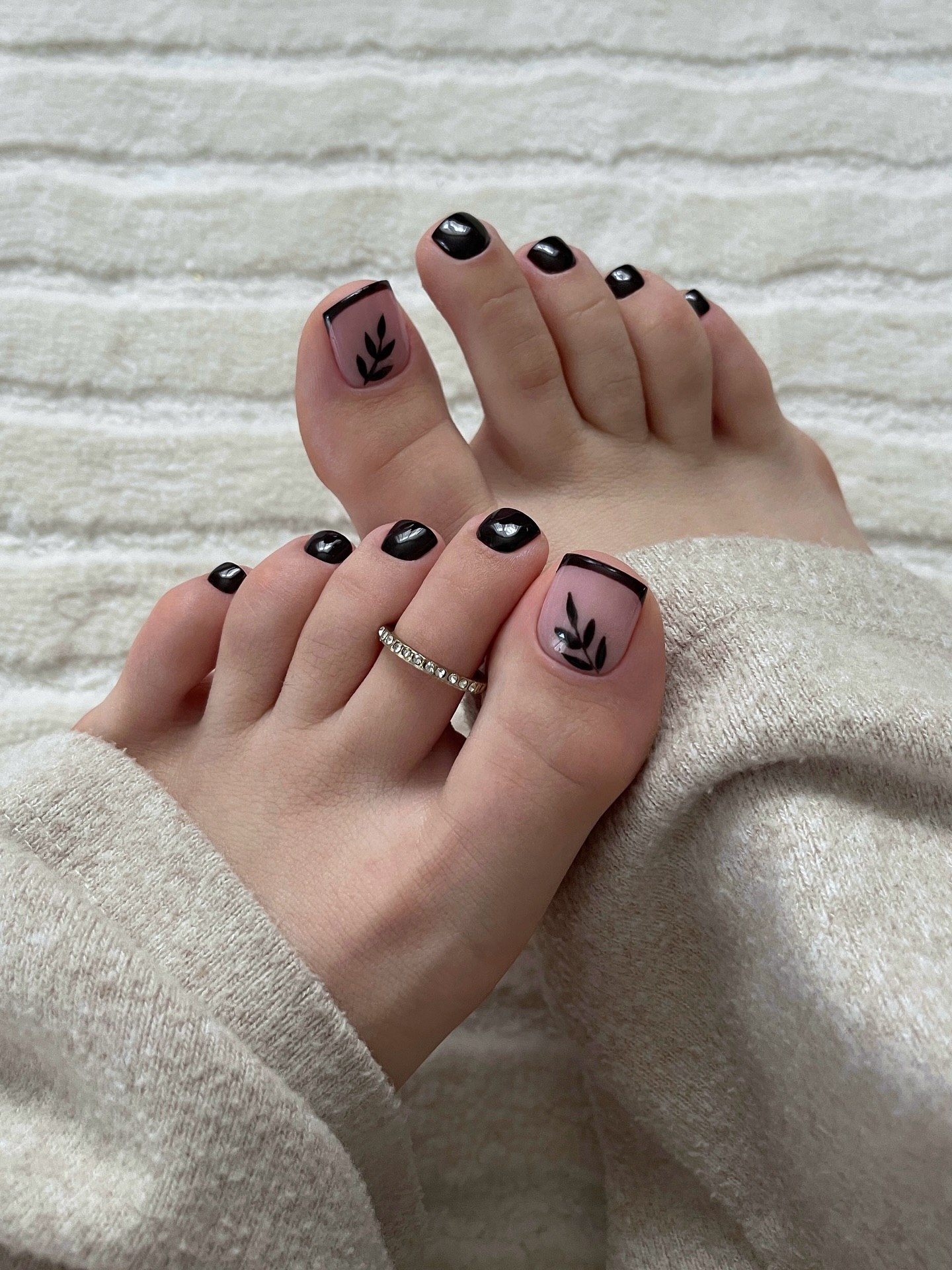 Black French Tip Pedicure with Leaf Detail