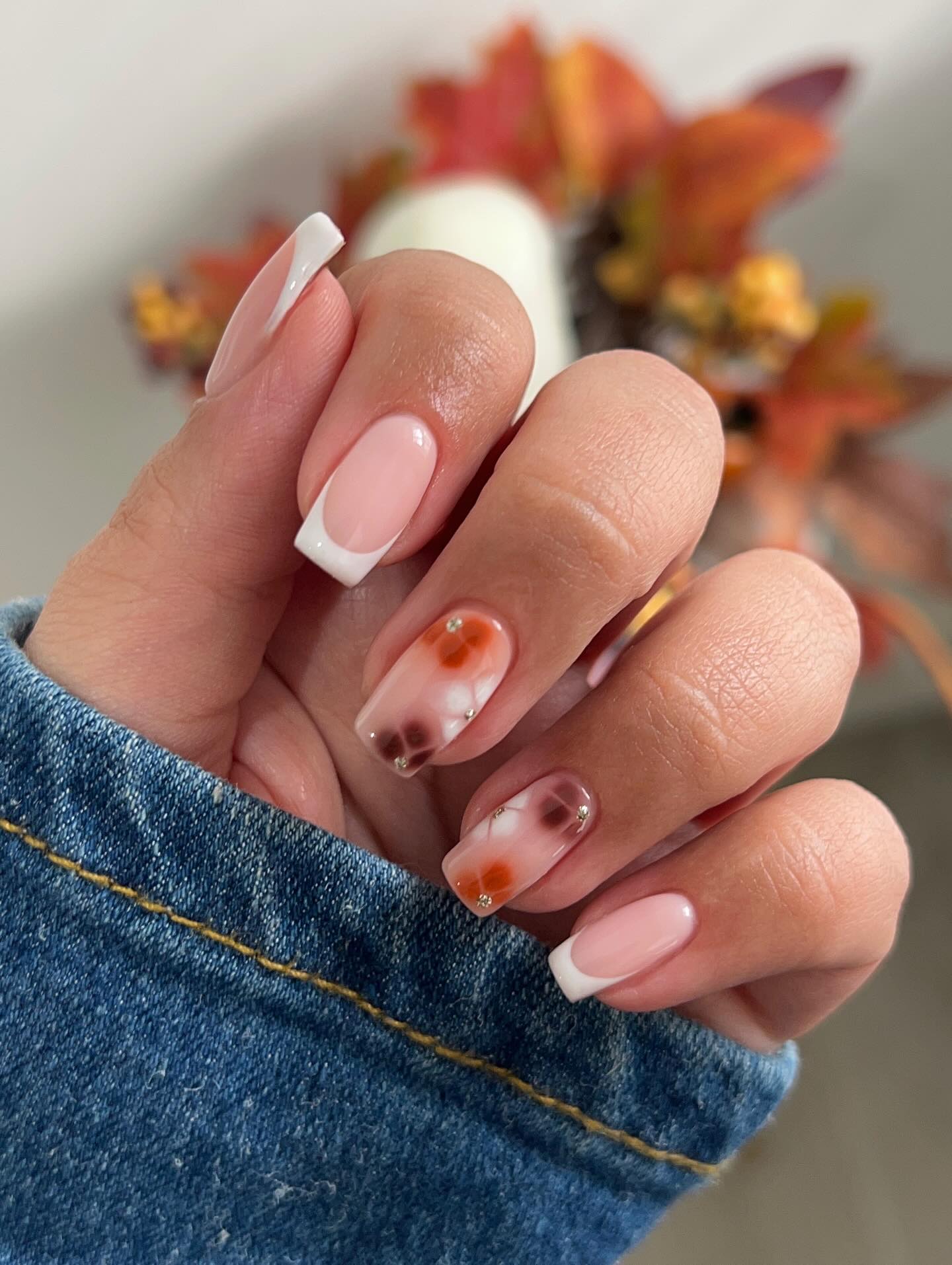 French Tip Nails with Floral Accents and Rhinestones