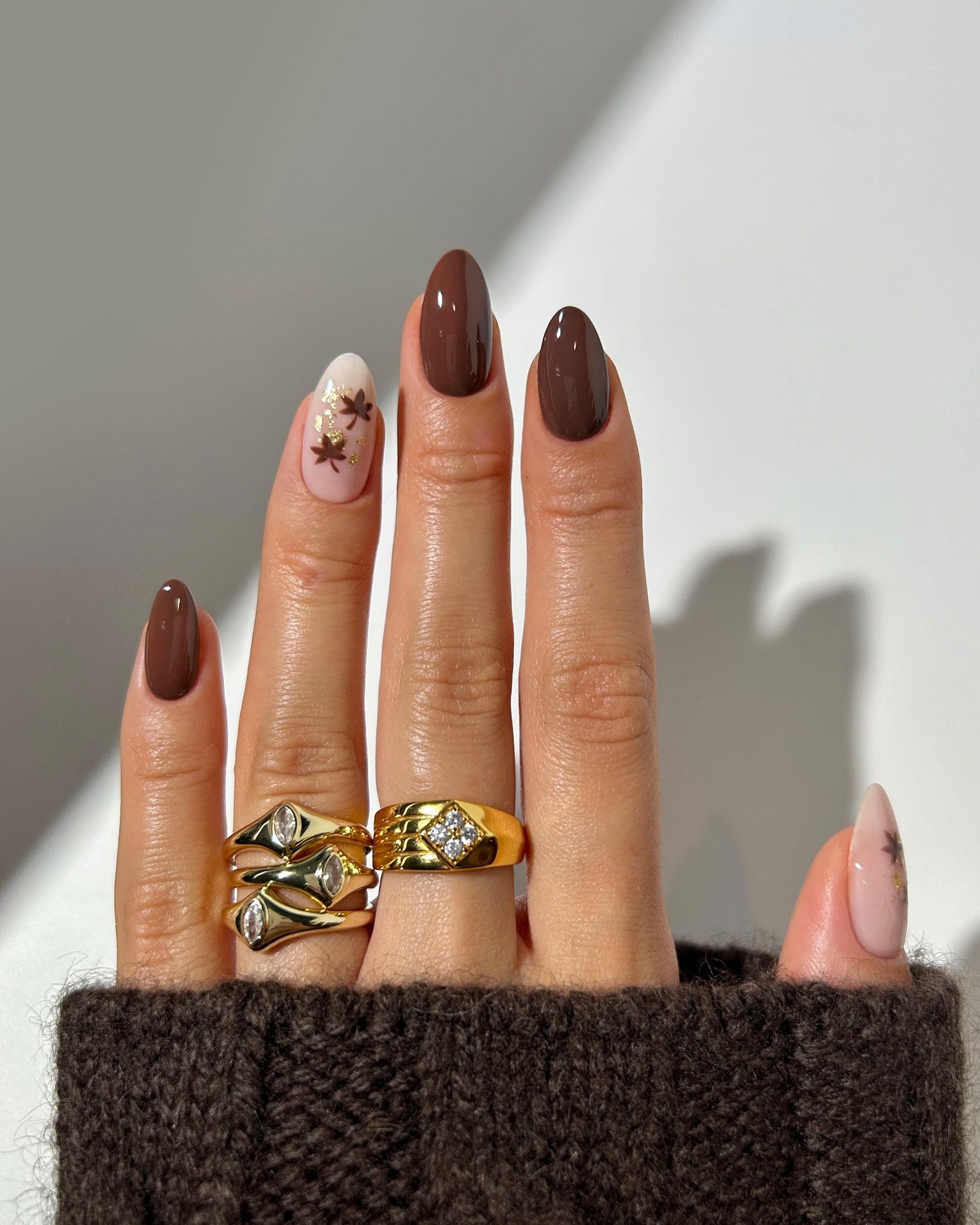 Rich Chocolate Almond Nails with Subtle Leaf Accents