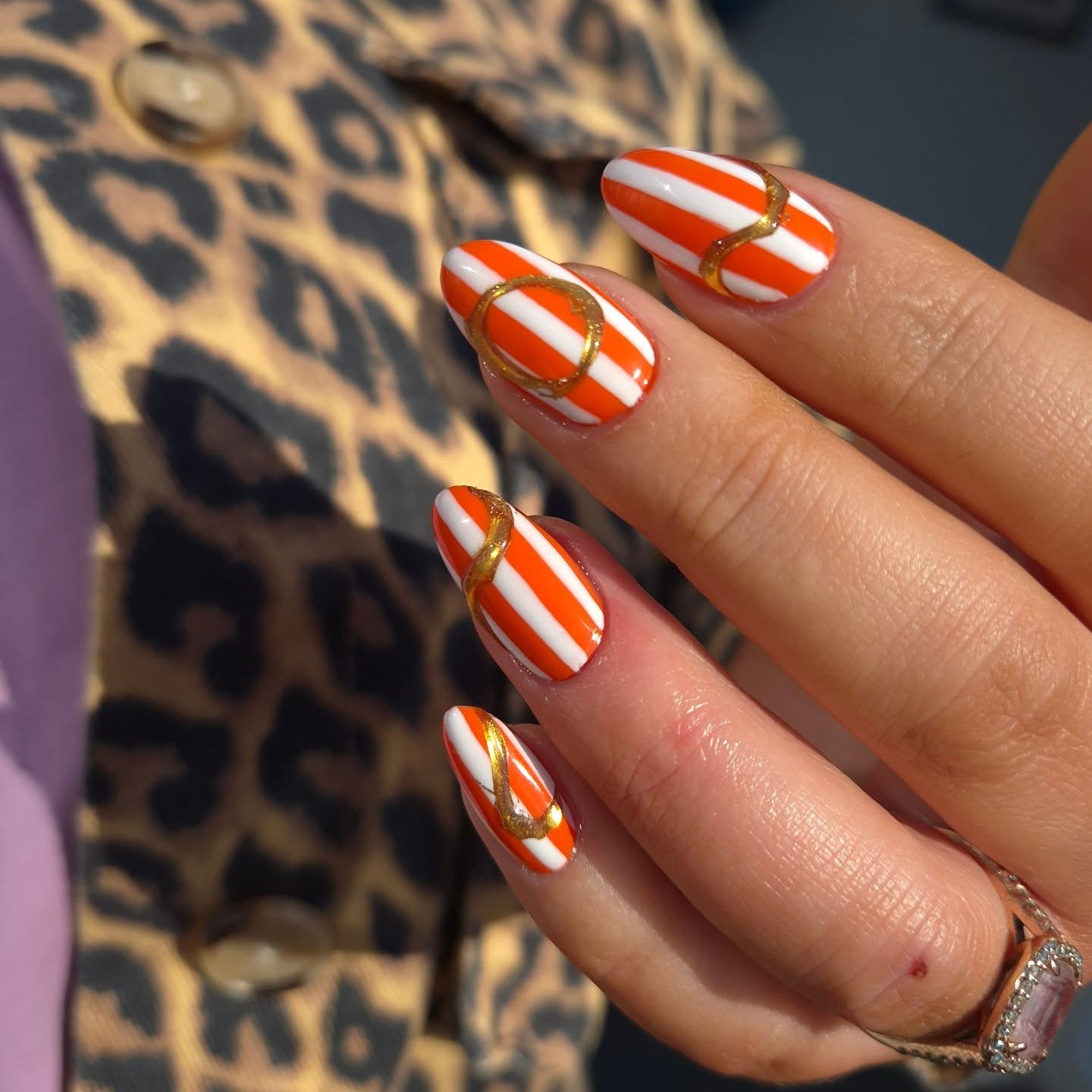 Orange and White Striped Oval Nails with Gold Swirls