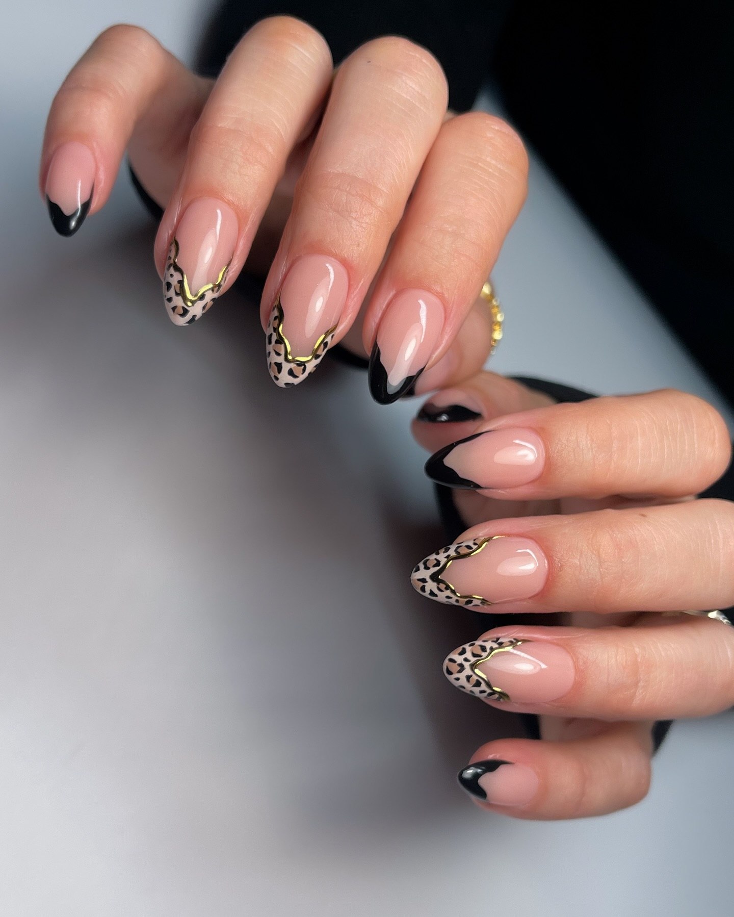 Leopard Print French Tip Almond Nails with Gold Accents