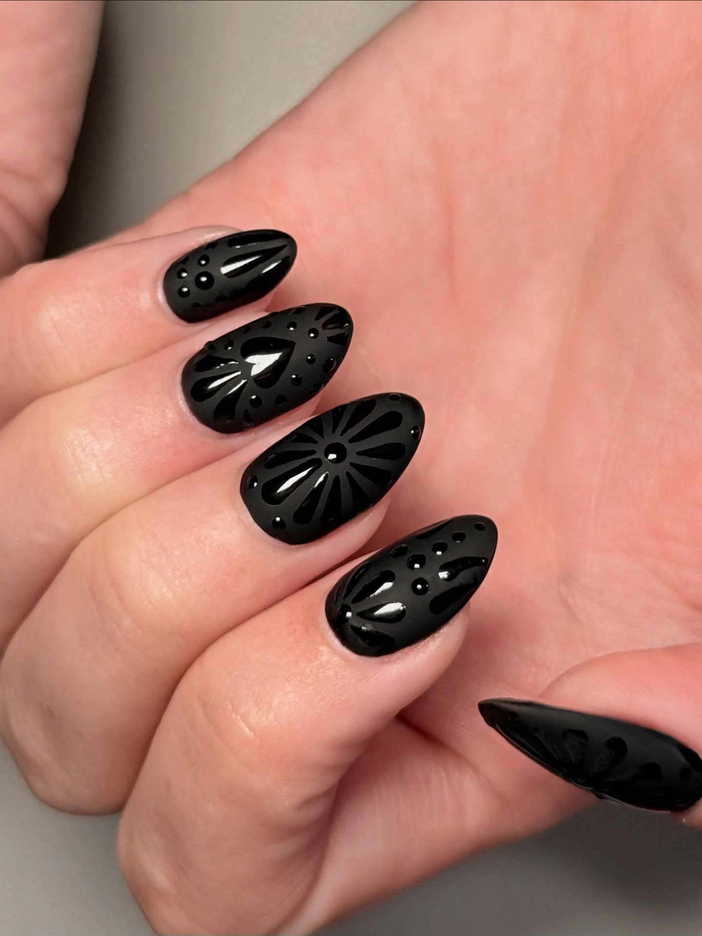 Matte Black Embossed Floral Almond Nails
